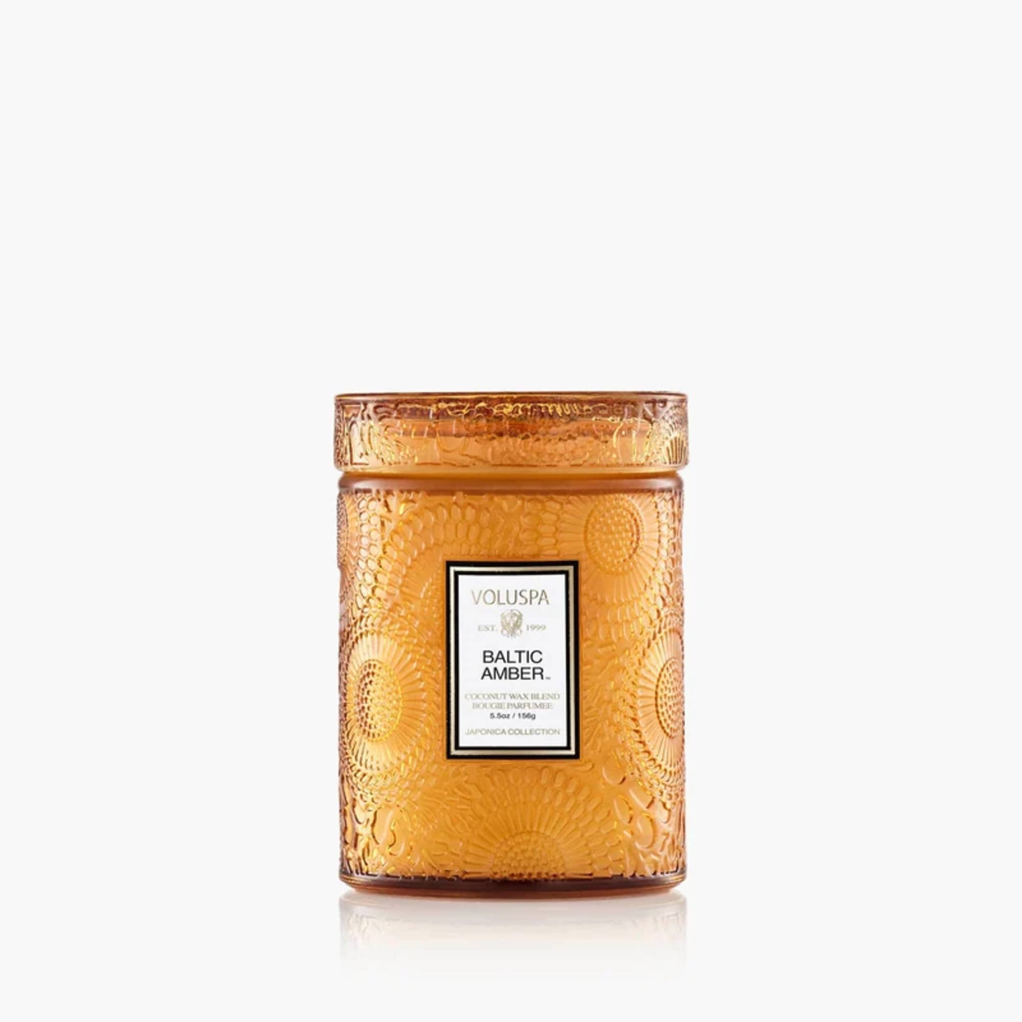 Amber glass candle jar with a lid and label