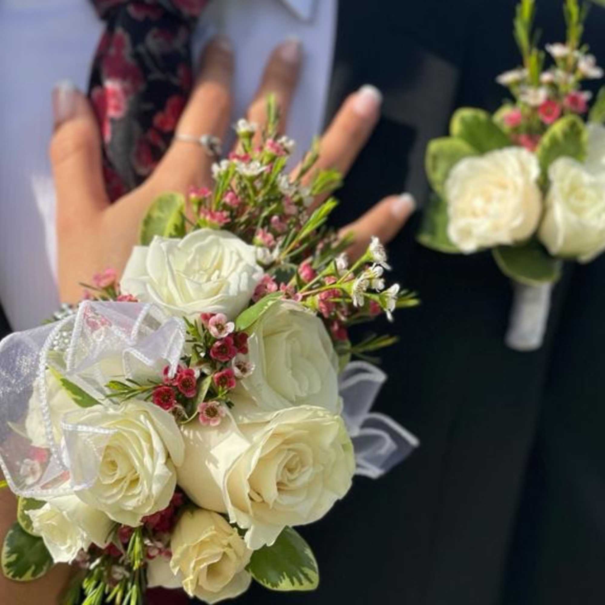 White rose bouquet and matching boutonniere on a suit jacket