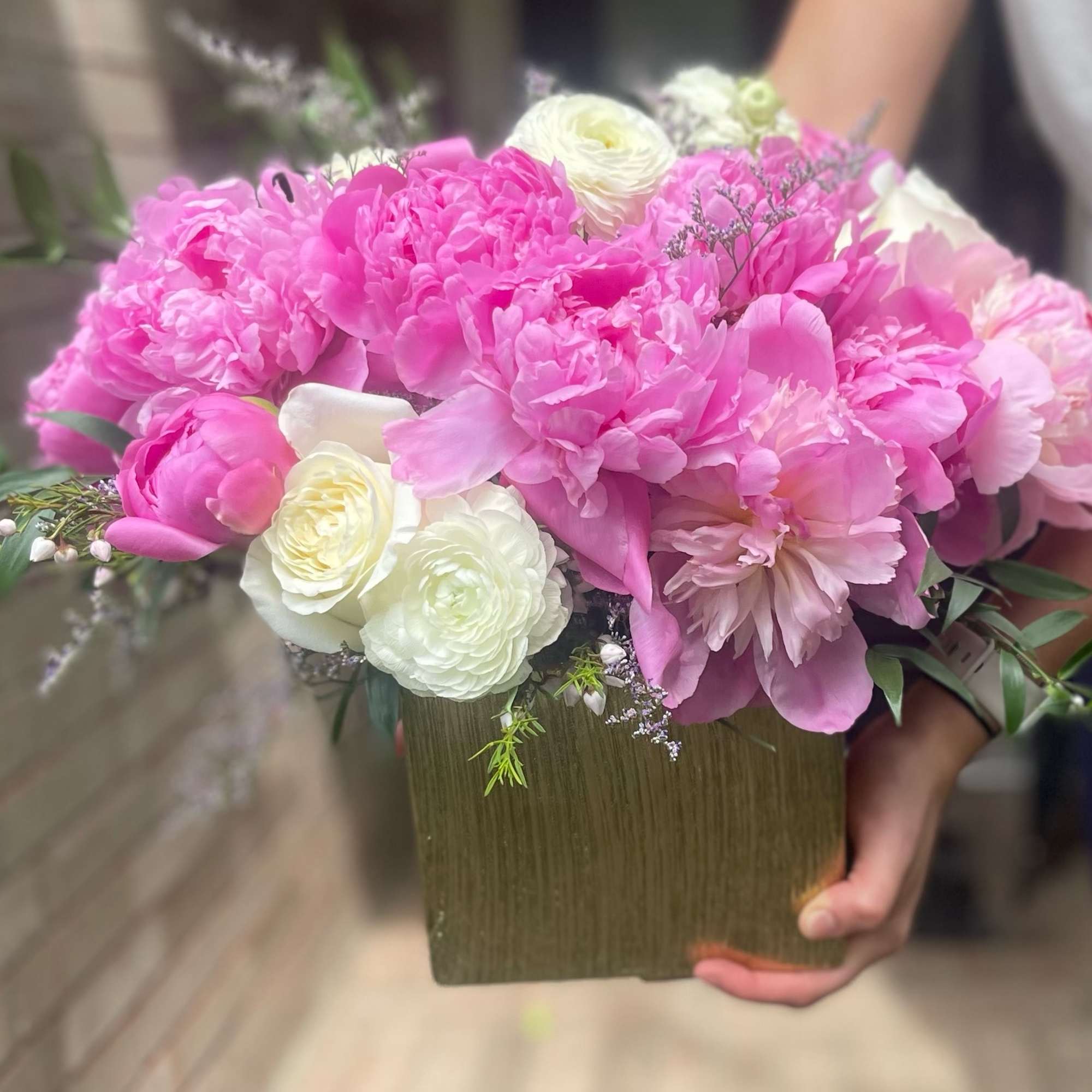 Pink and white bouquet in a square vase