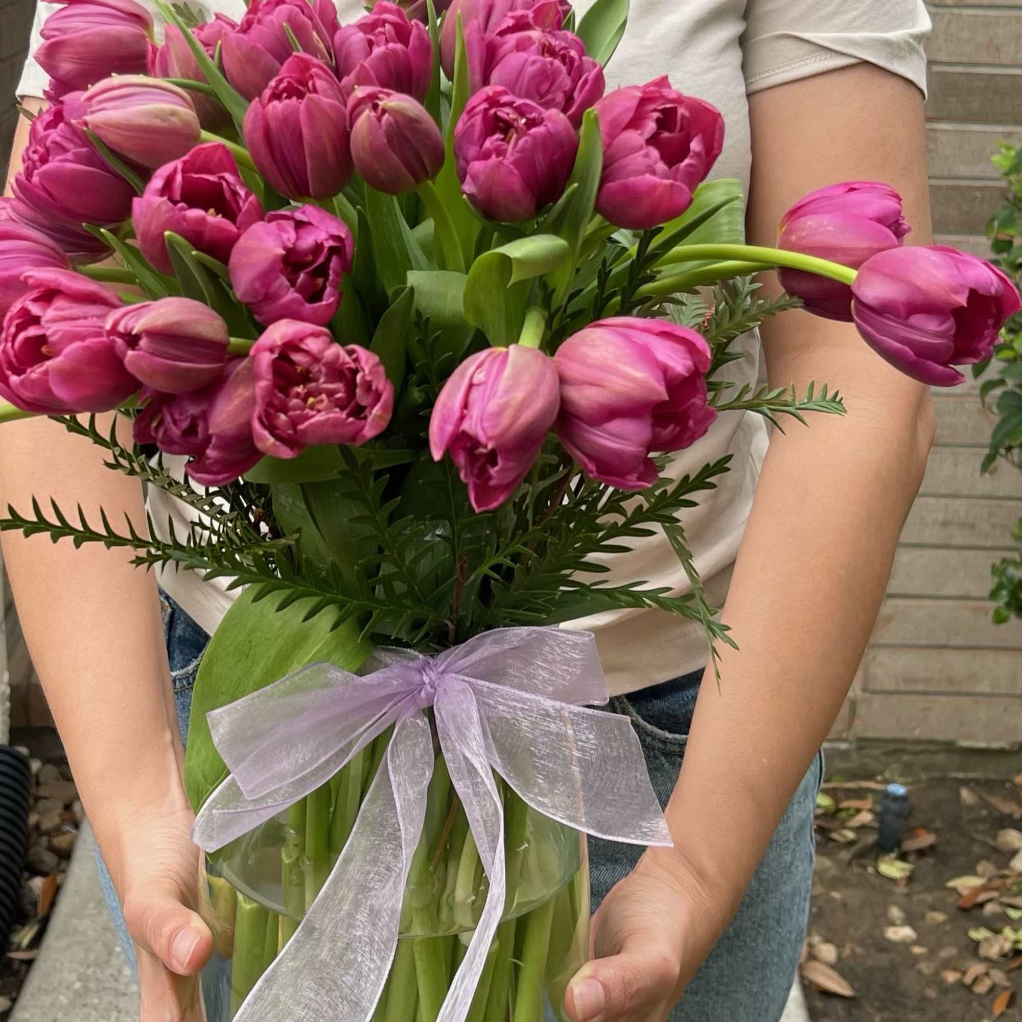 Bouquet of pink tulips wrapped with a lavender ribbon