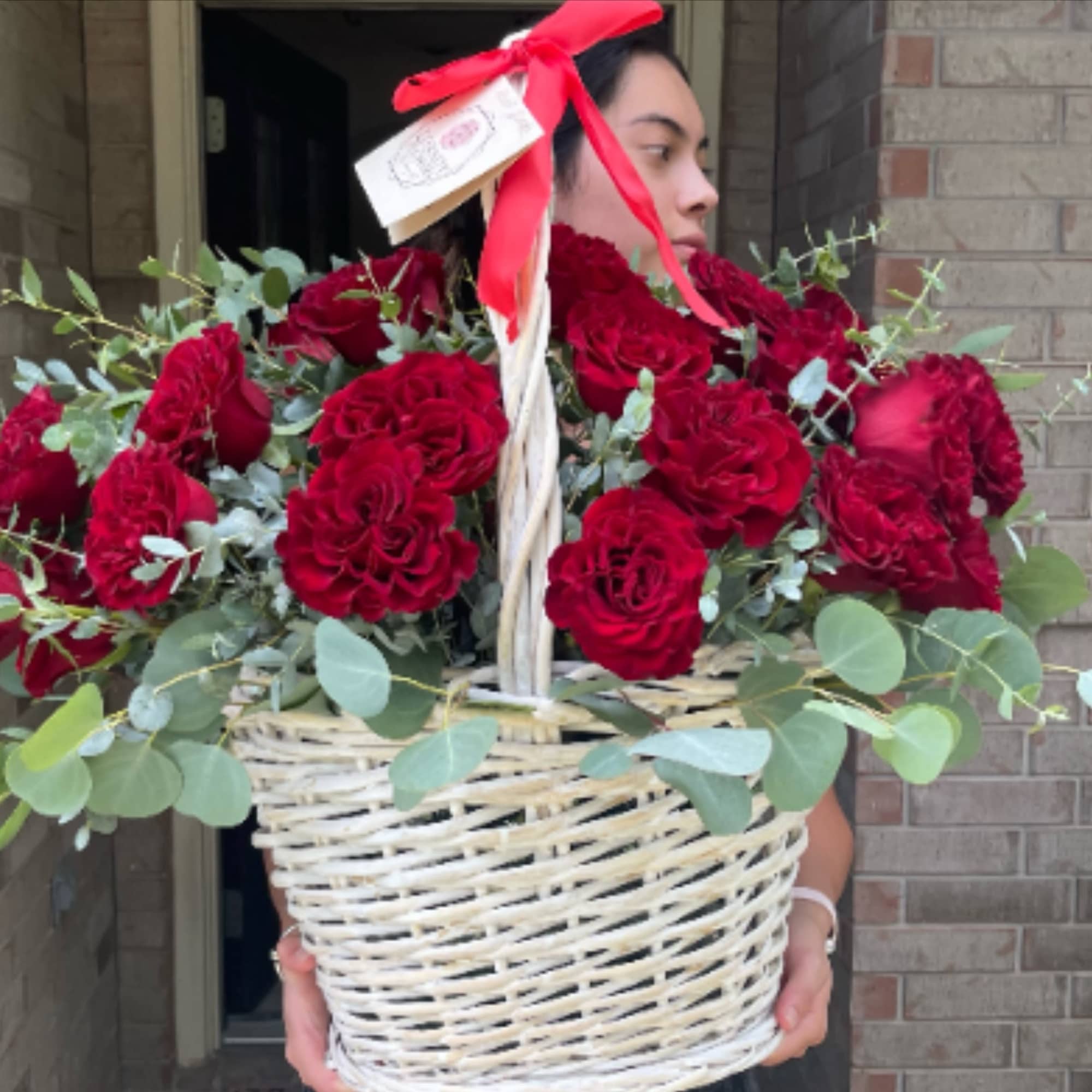 Basket of red roses with eucalyptus and a red ribbon, photo 2 of 3