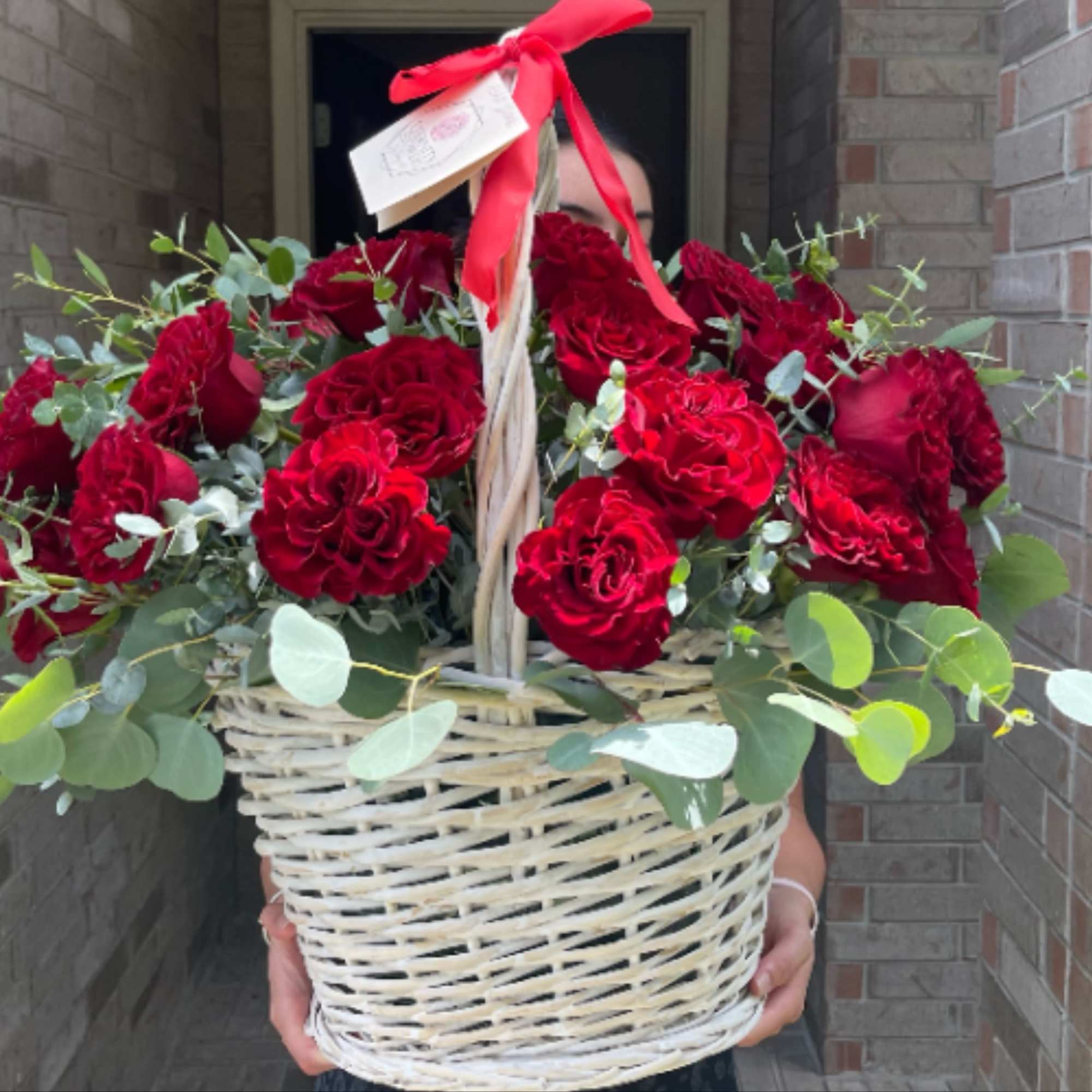 Basket of red roses with eucalyptus and a red ribbon, photo 3 of 3