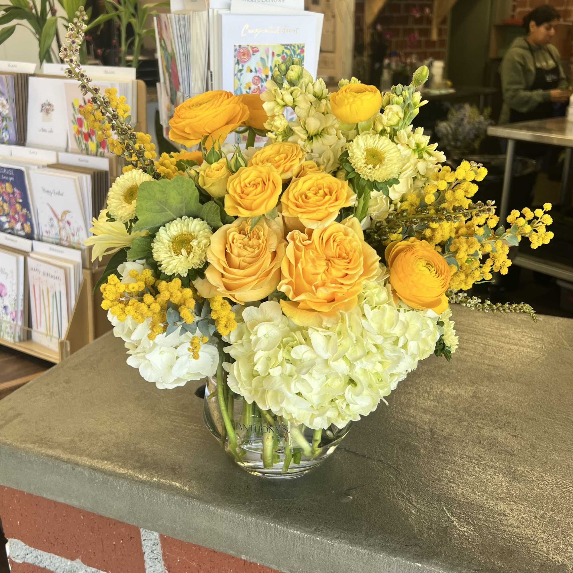 Yellow roses and white hydrangeas in a glass vase