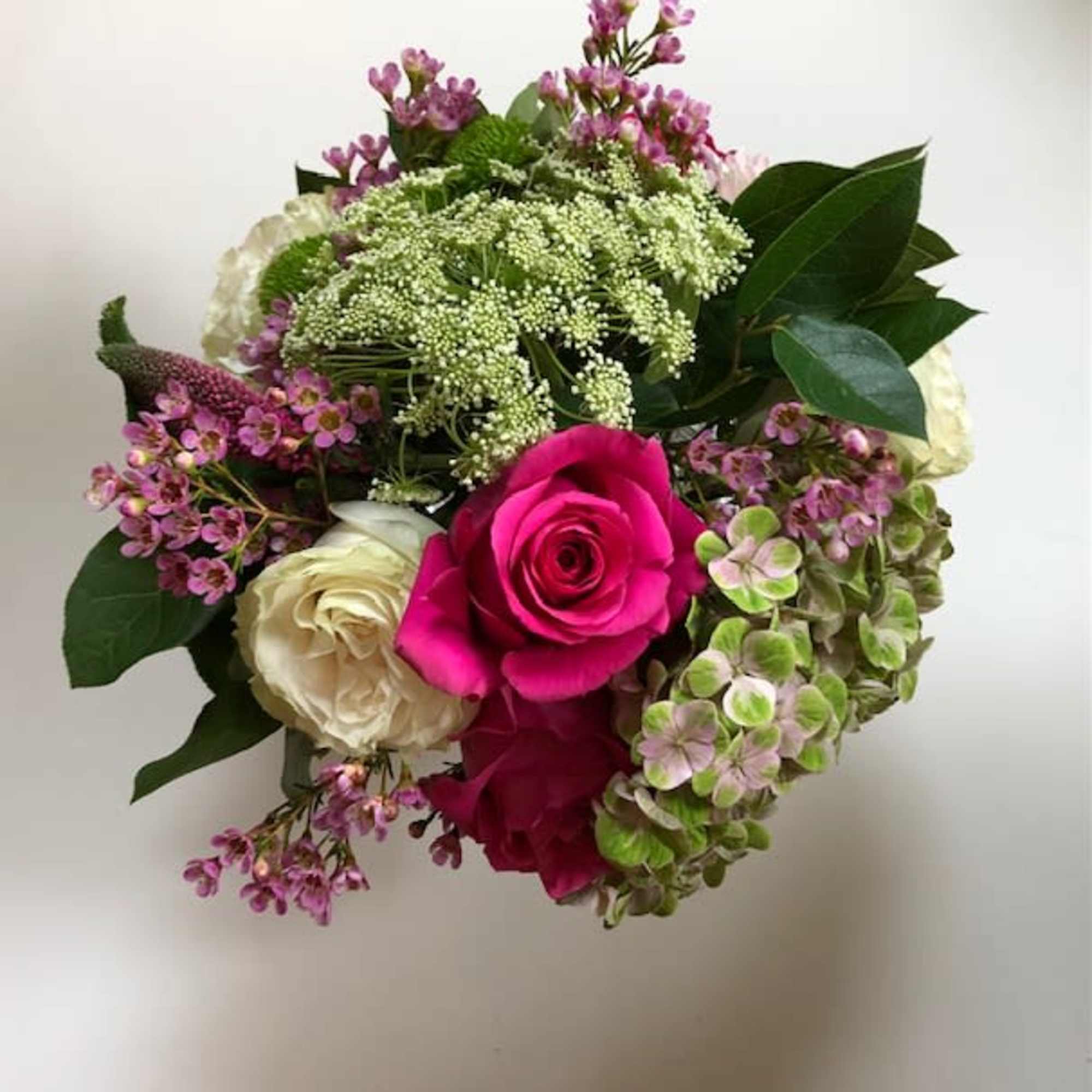 Bouquet of pink and white roses with purple filler flowers