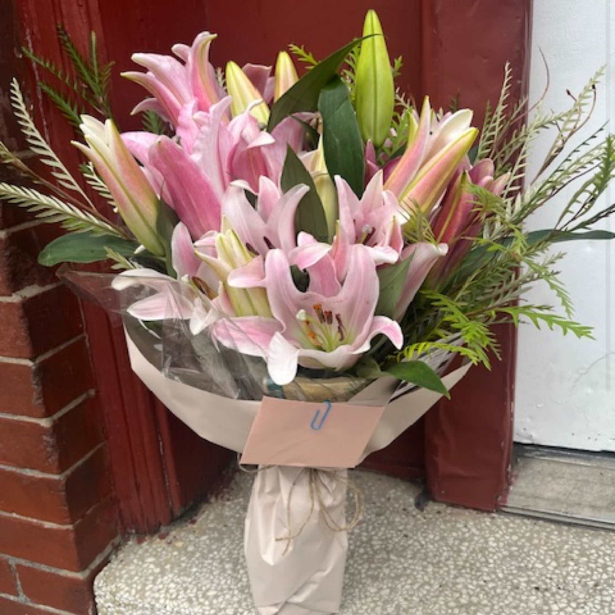 Bouquet of pink lilies wrapped in paper