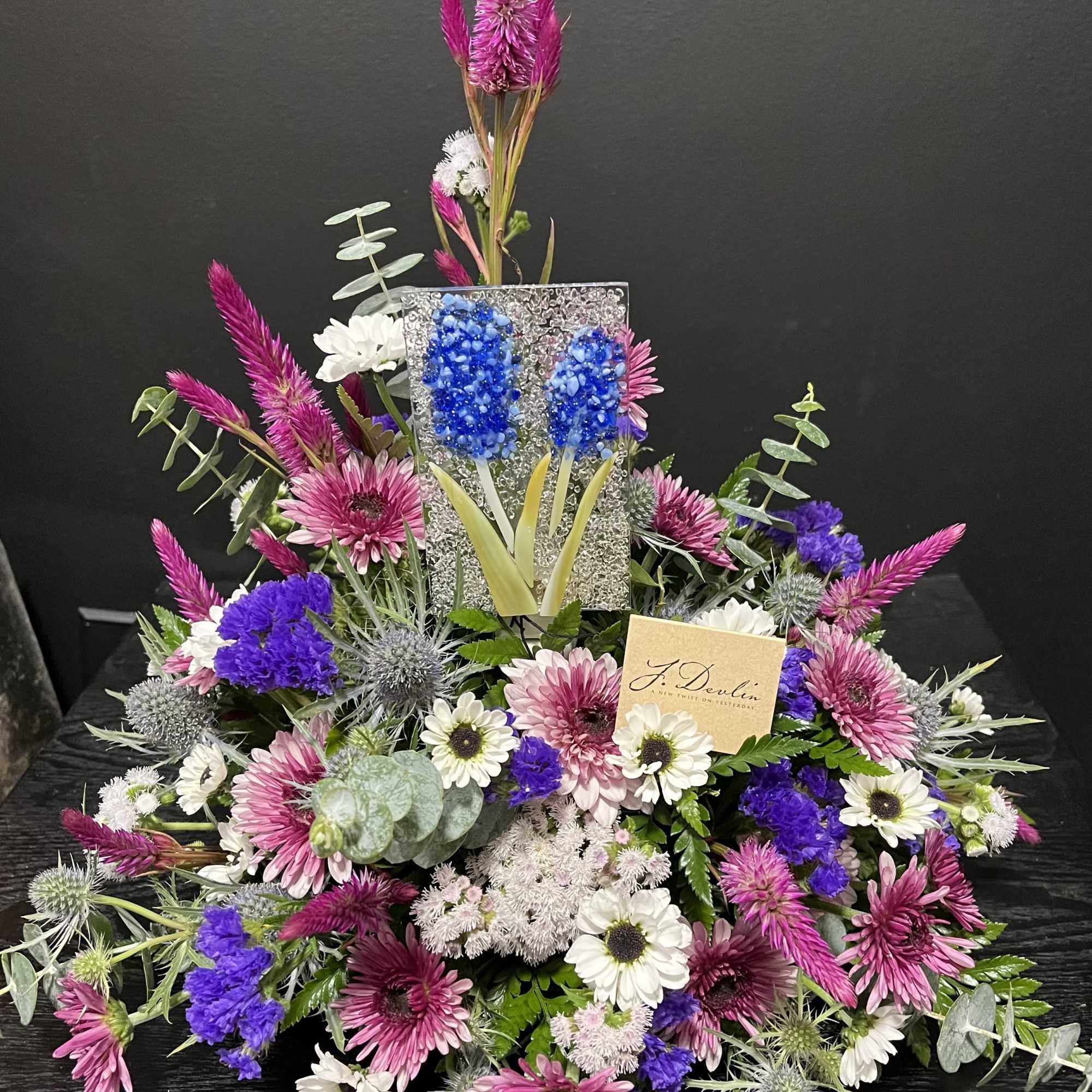 Large mixed floral arrangement with pink, white, and purple blooms