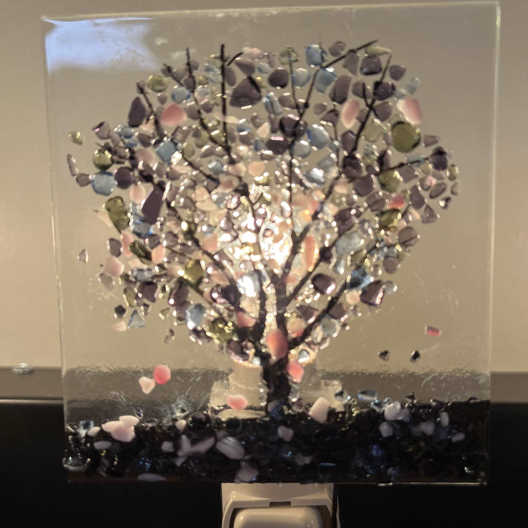 Decorative glass panel with a tree made of colorful stones