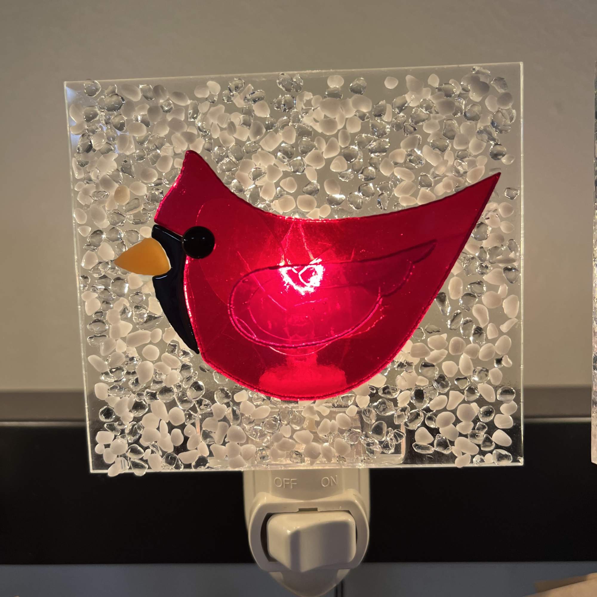 Red cardinal night light with a textured clear glass panel