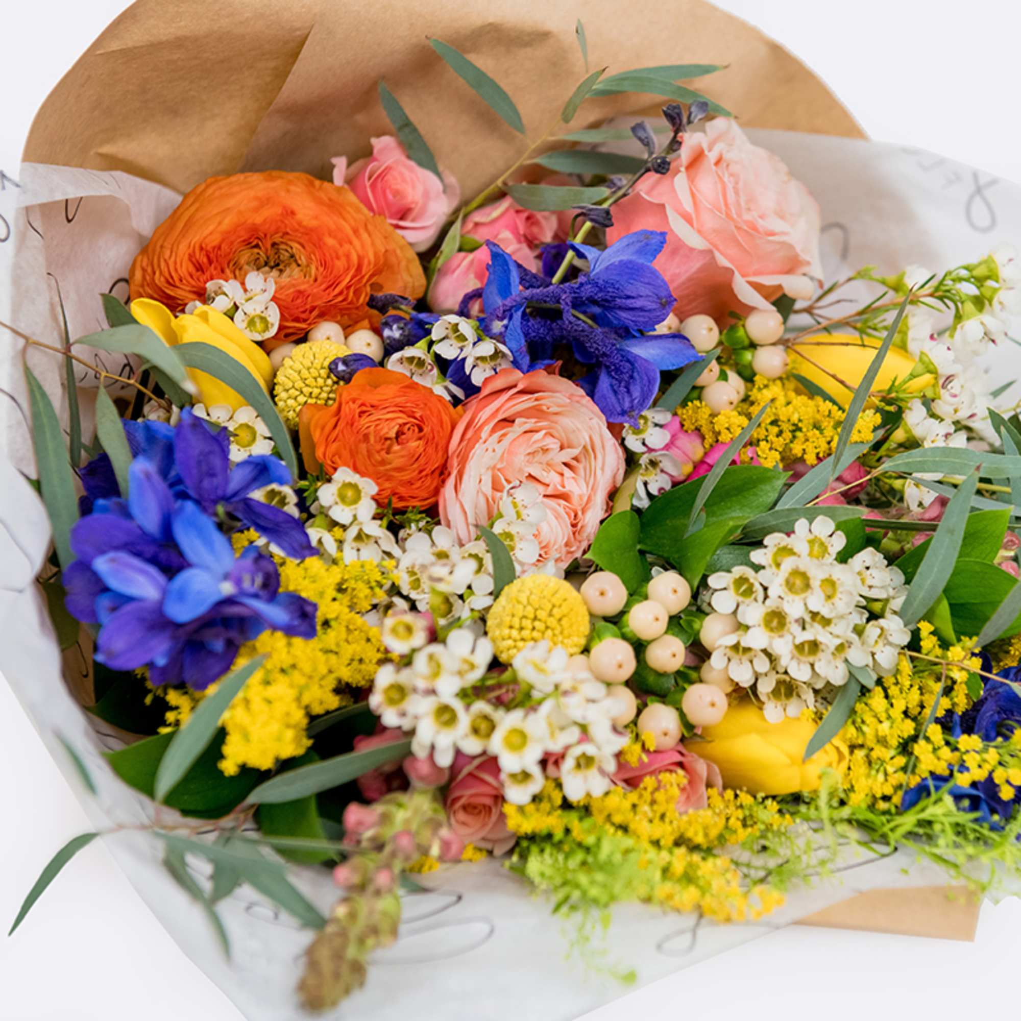 Colorful mixed bouquet with orange, pink, yellow, and blue flowers