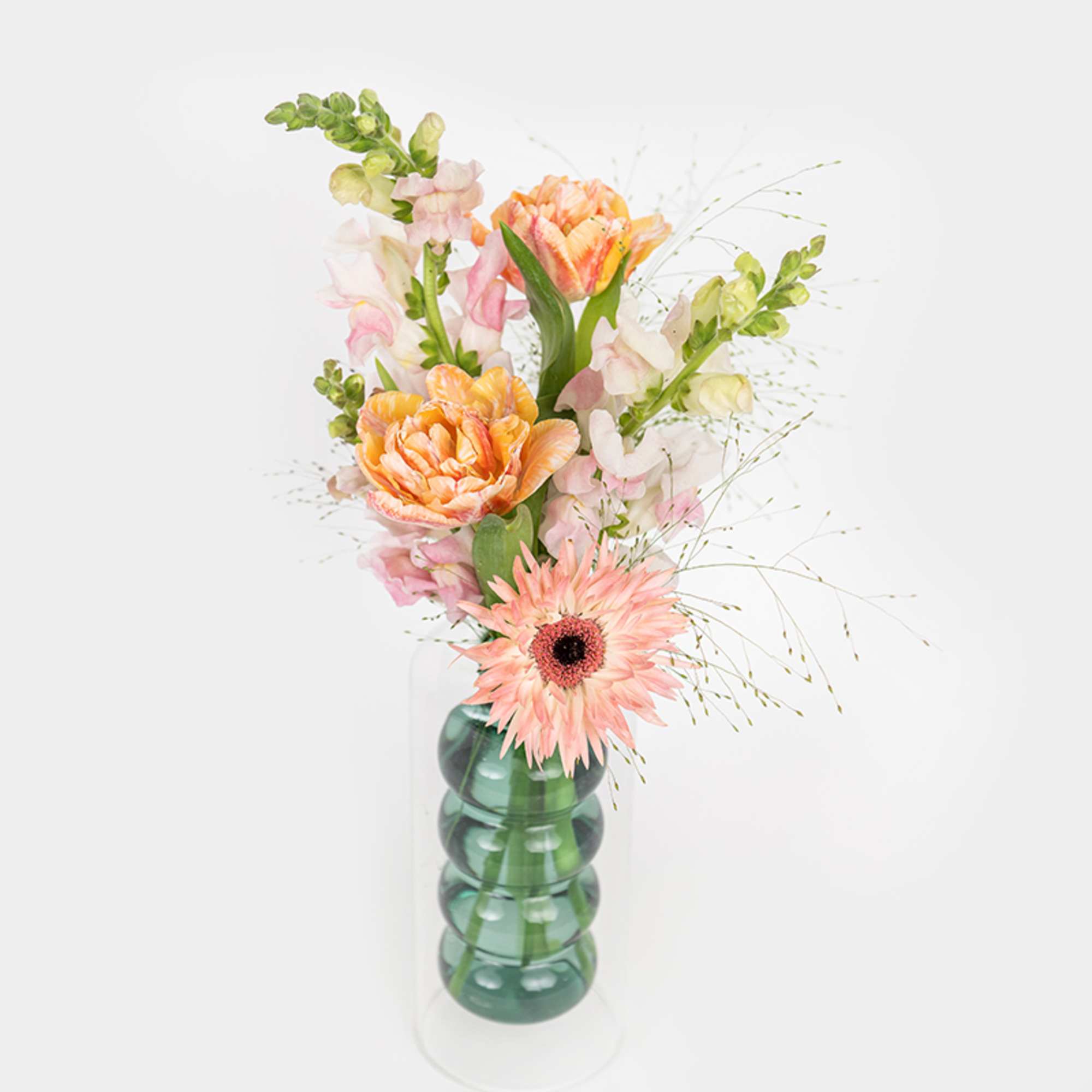 Pink and orange flowers in a clear glass vase