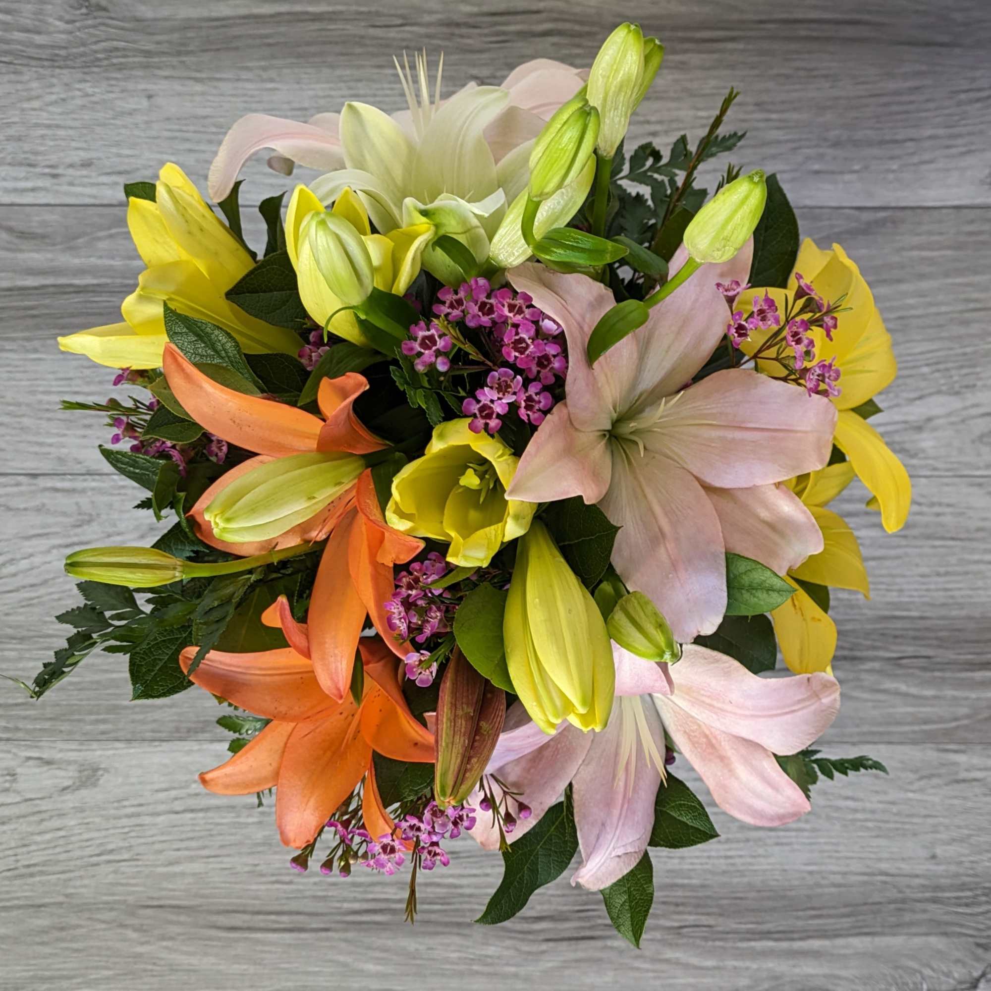 Bouquet of lilies in pink, yellow, orange, and white