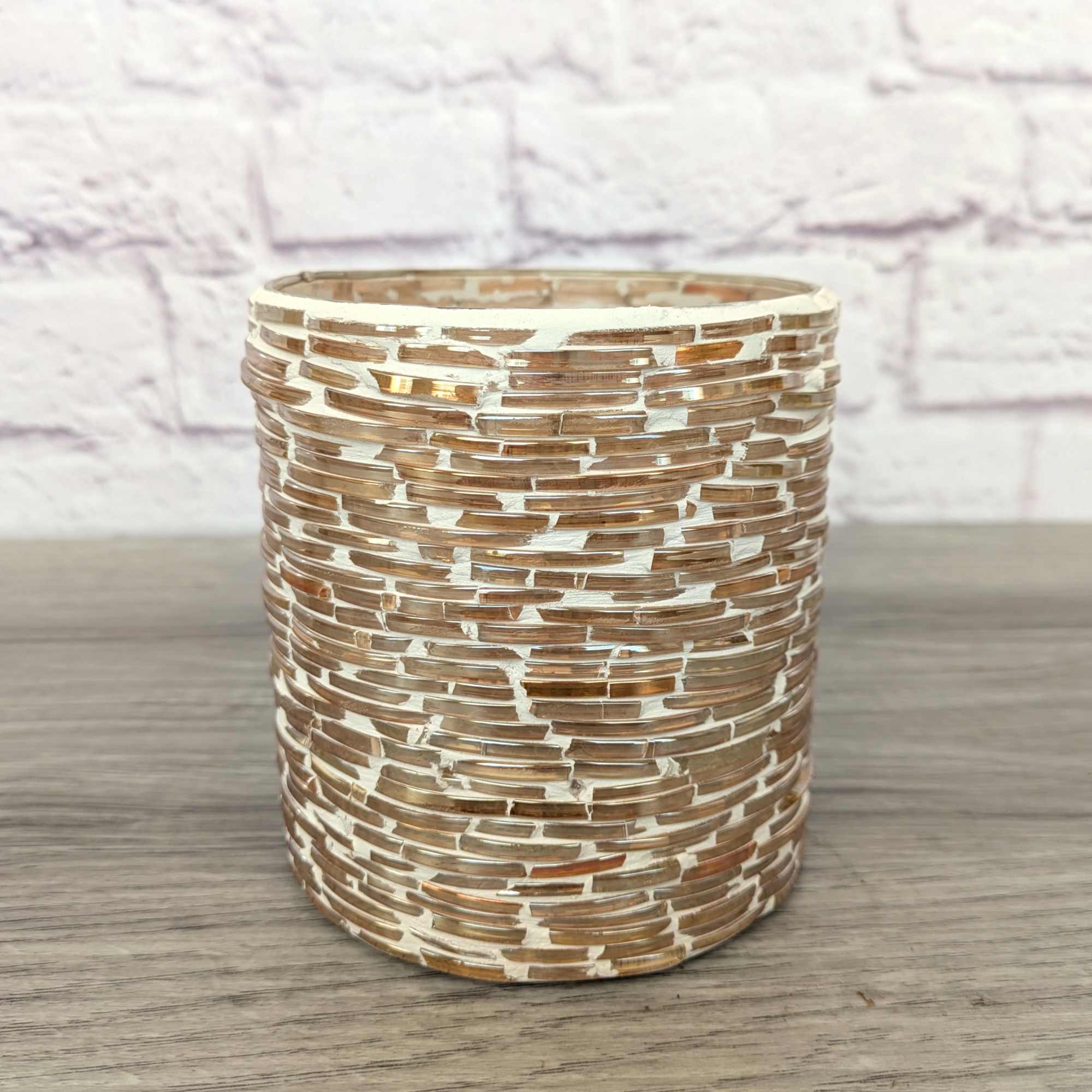 Textured cylindrical glass vase with a gold and white mosaic pattern