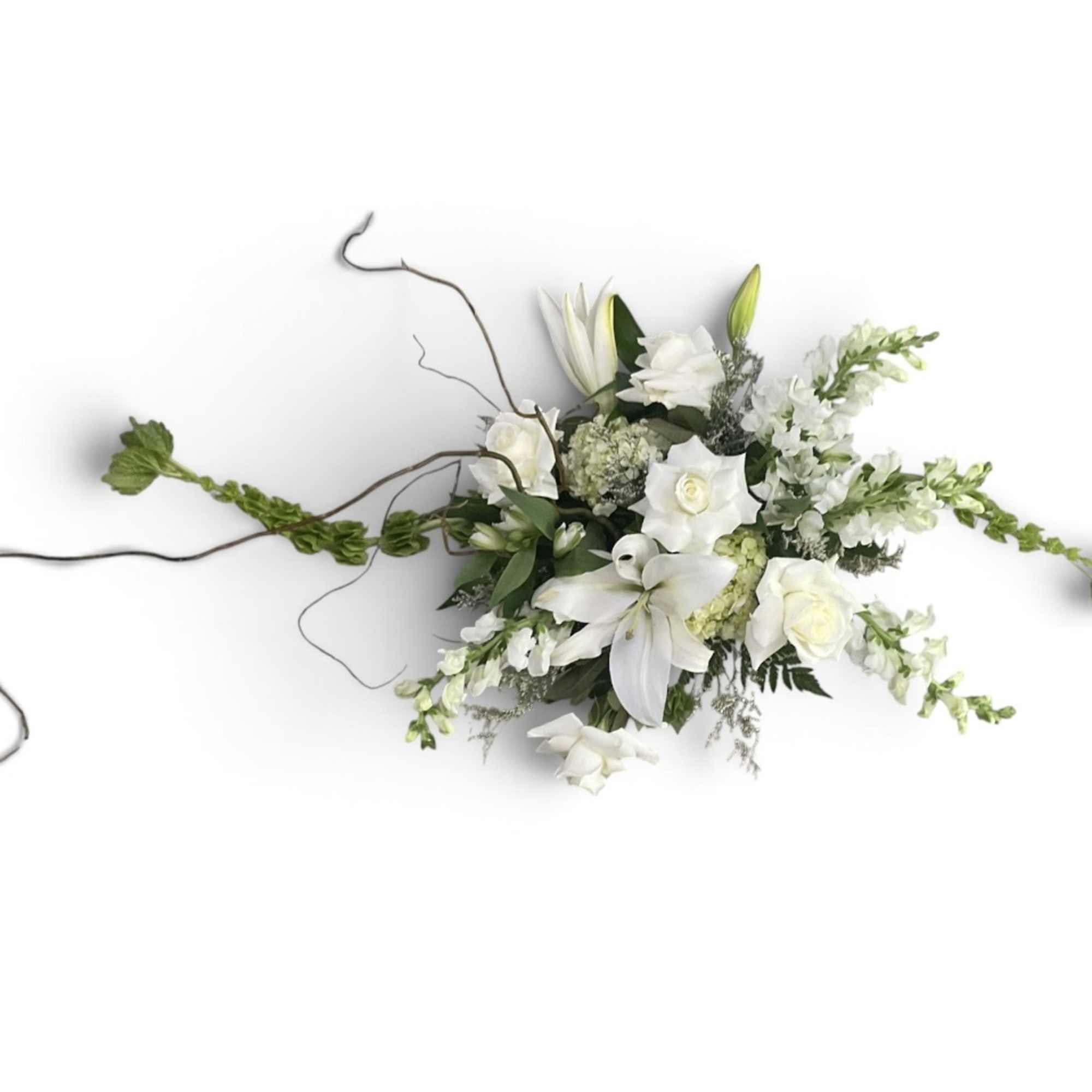 White floral arrangement with lilies and roses in a low design