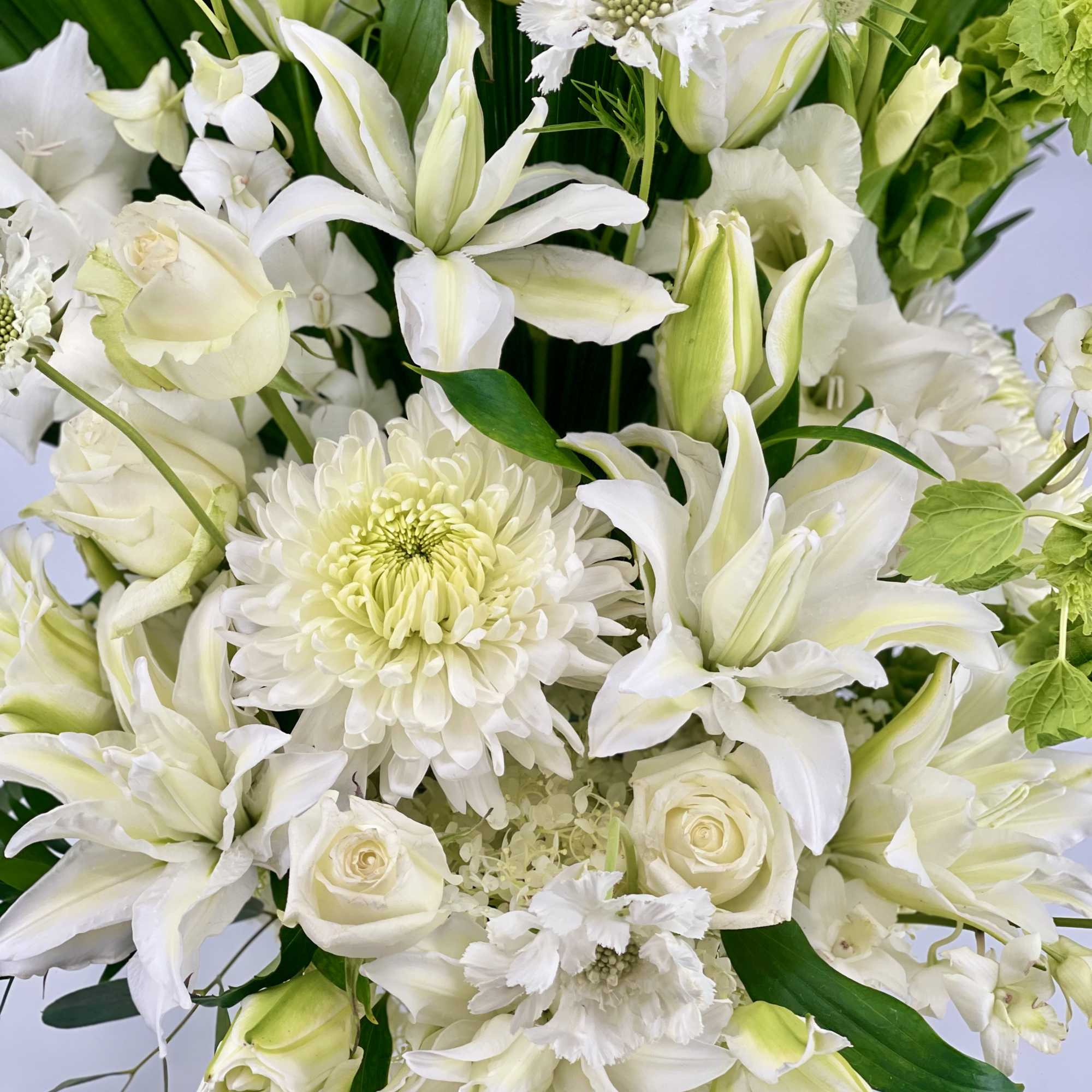 White floral bouquet with lilies, roses, and chrysanthemums