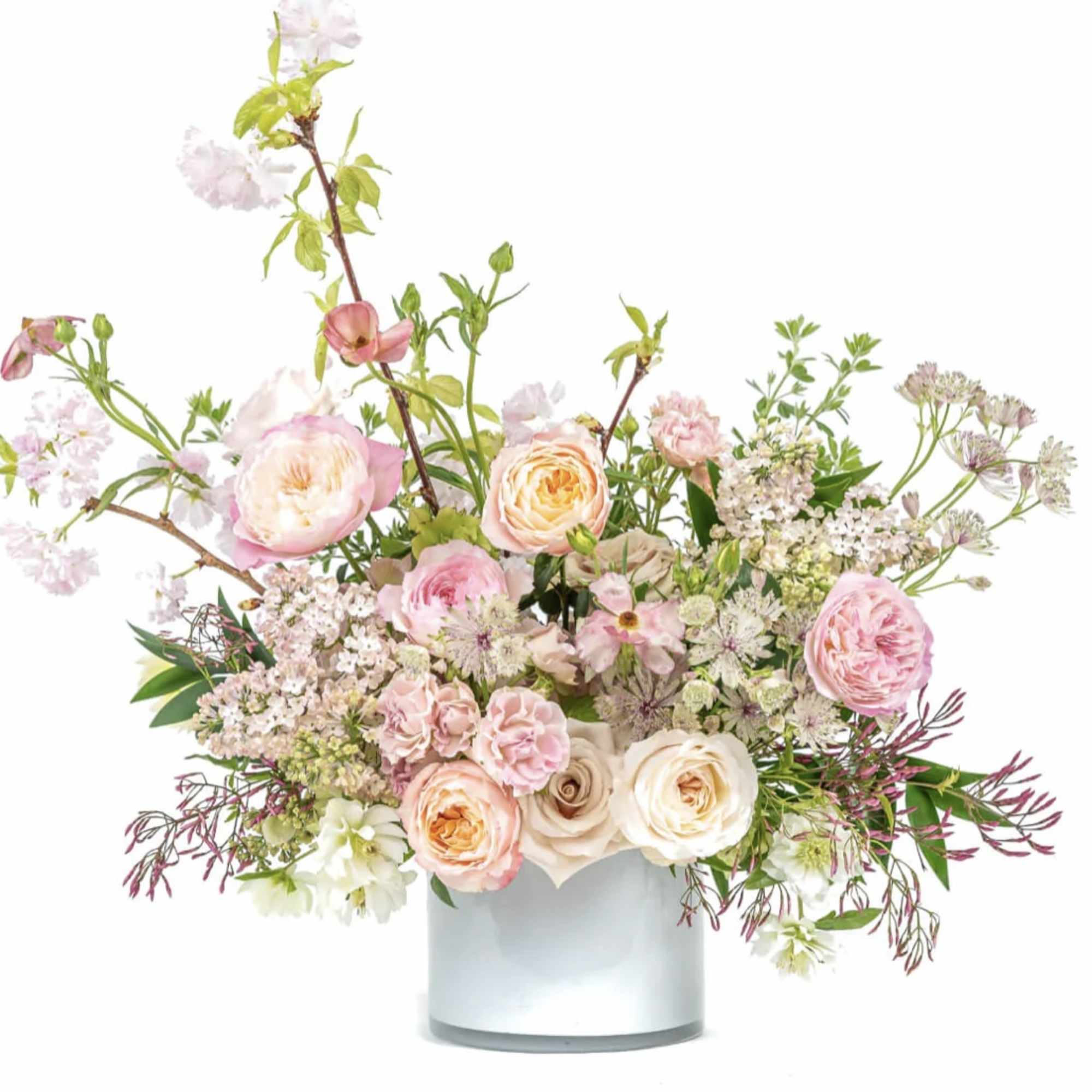 Pink and cream floral arrangement in a white vase