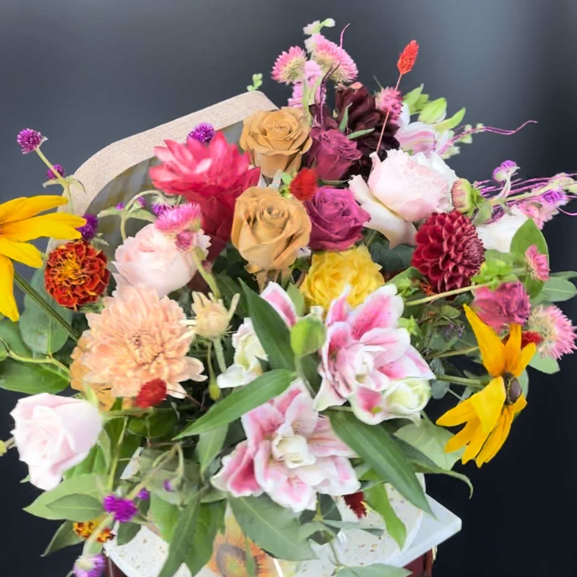 Mixed bouquet of colorful flowers in a gift box