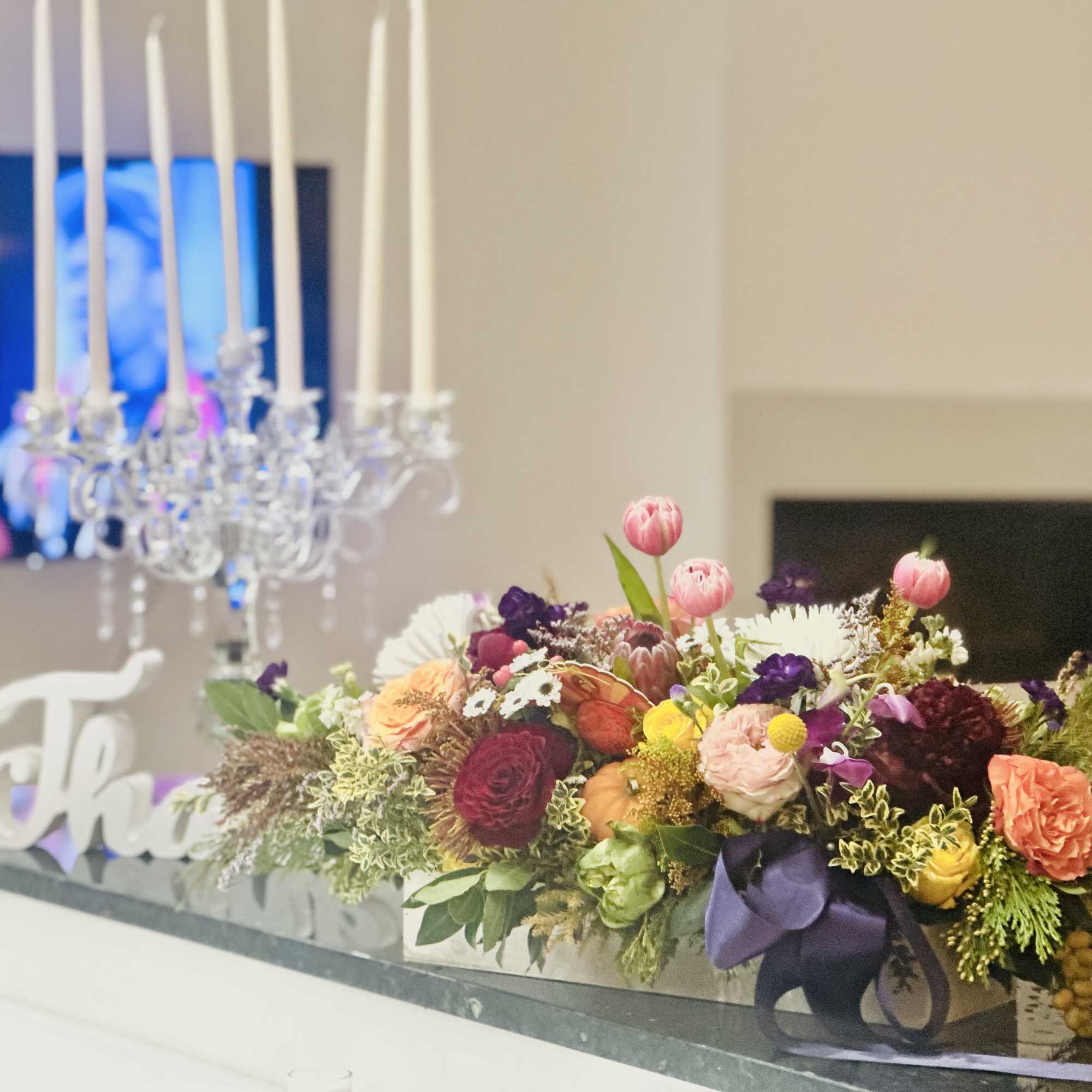 Low floral centerpiece with mixed blooms in a rectangular container