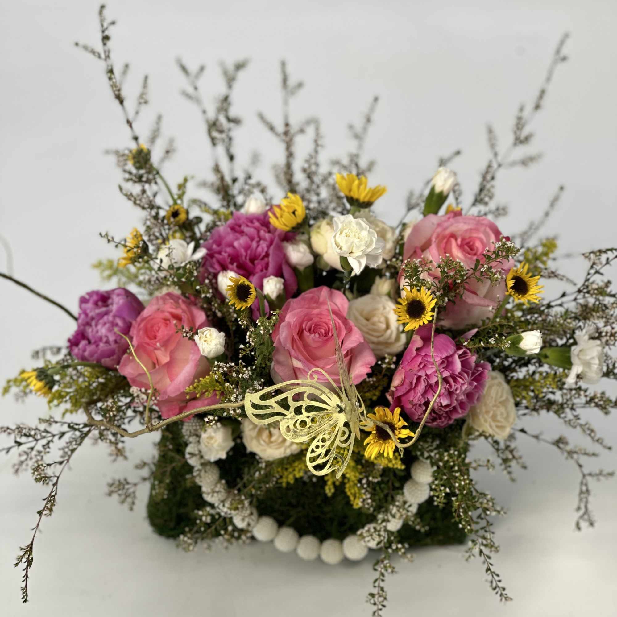 Pink and white rose bouquet with yellow daisies and a butterfly decoration