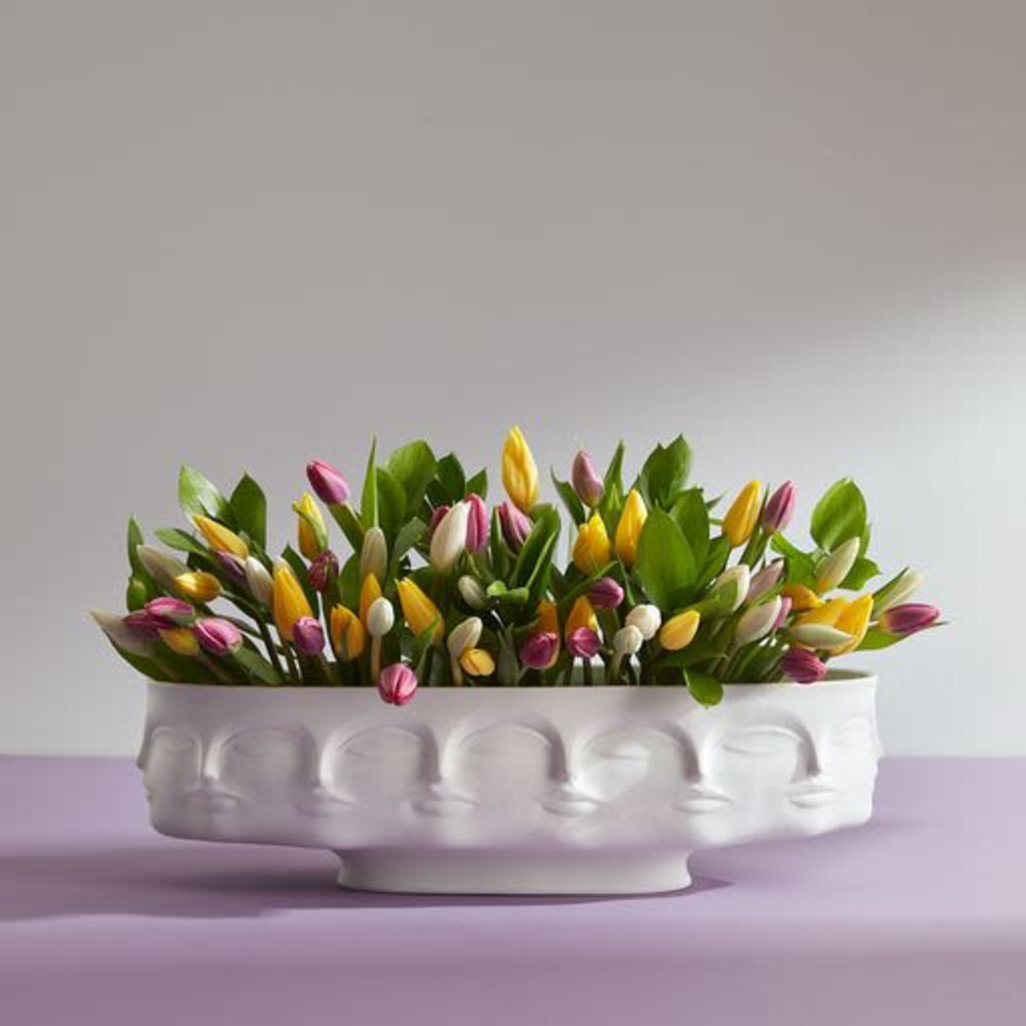 Colorful tulips arranged in a white decorative bowl