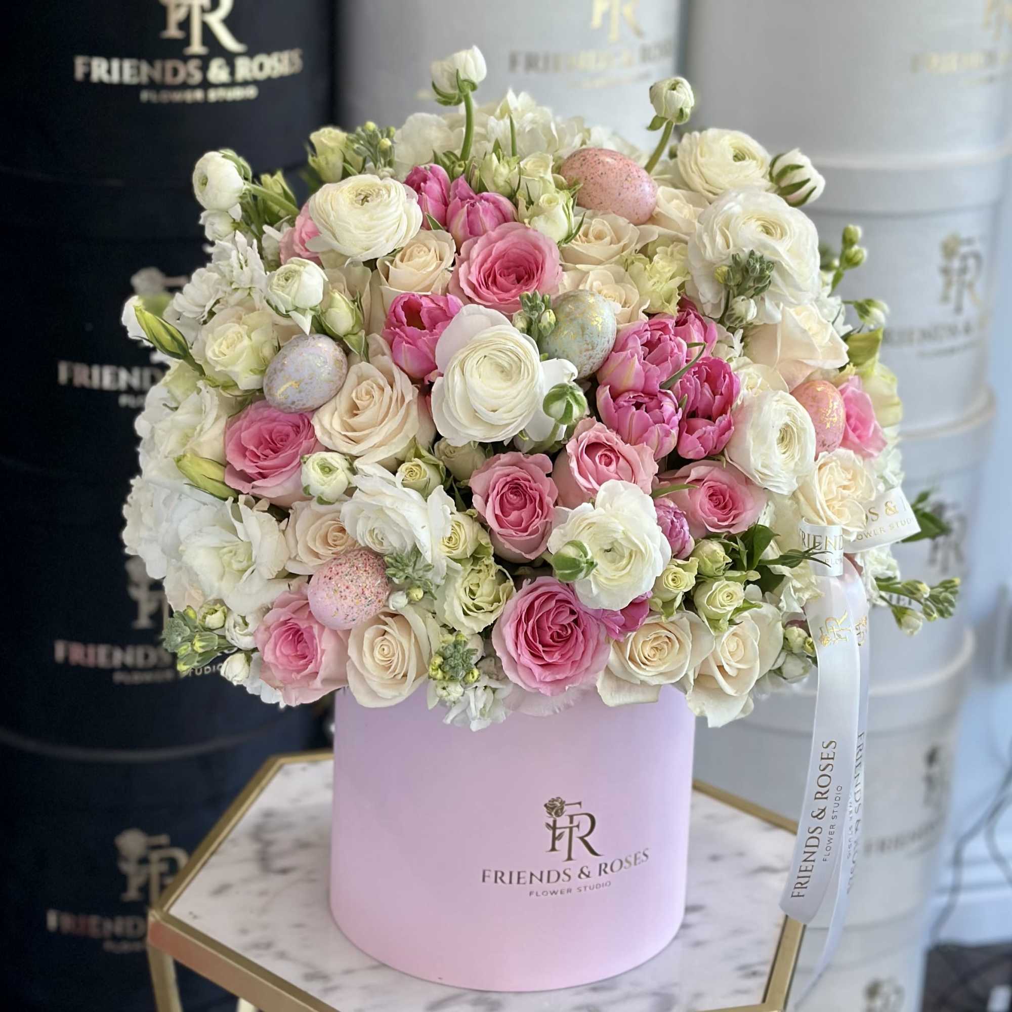 Pink and white rose bouquet in a pastel pink hat box