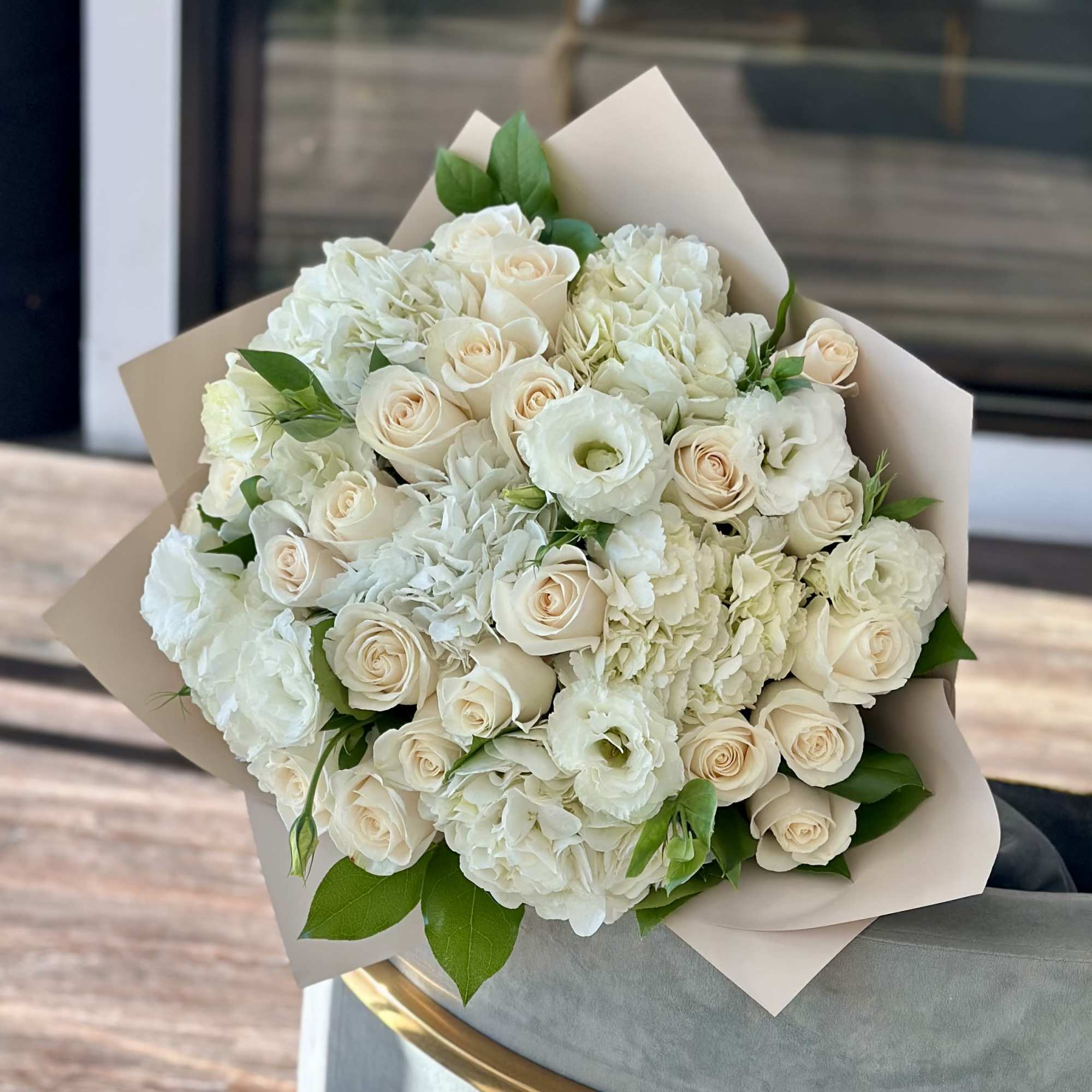 Bouquet of white roses and white hydrangeas wrapped in beige paper, photo 2 of 2