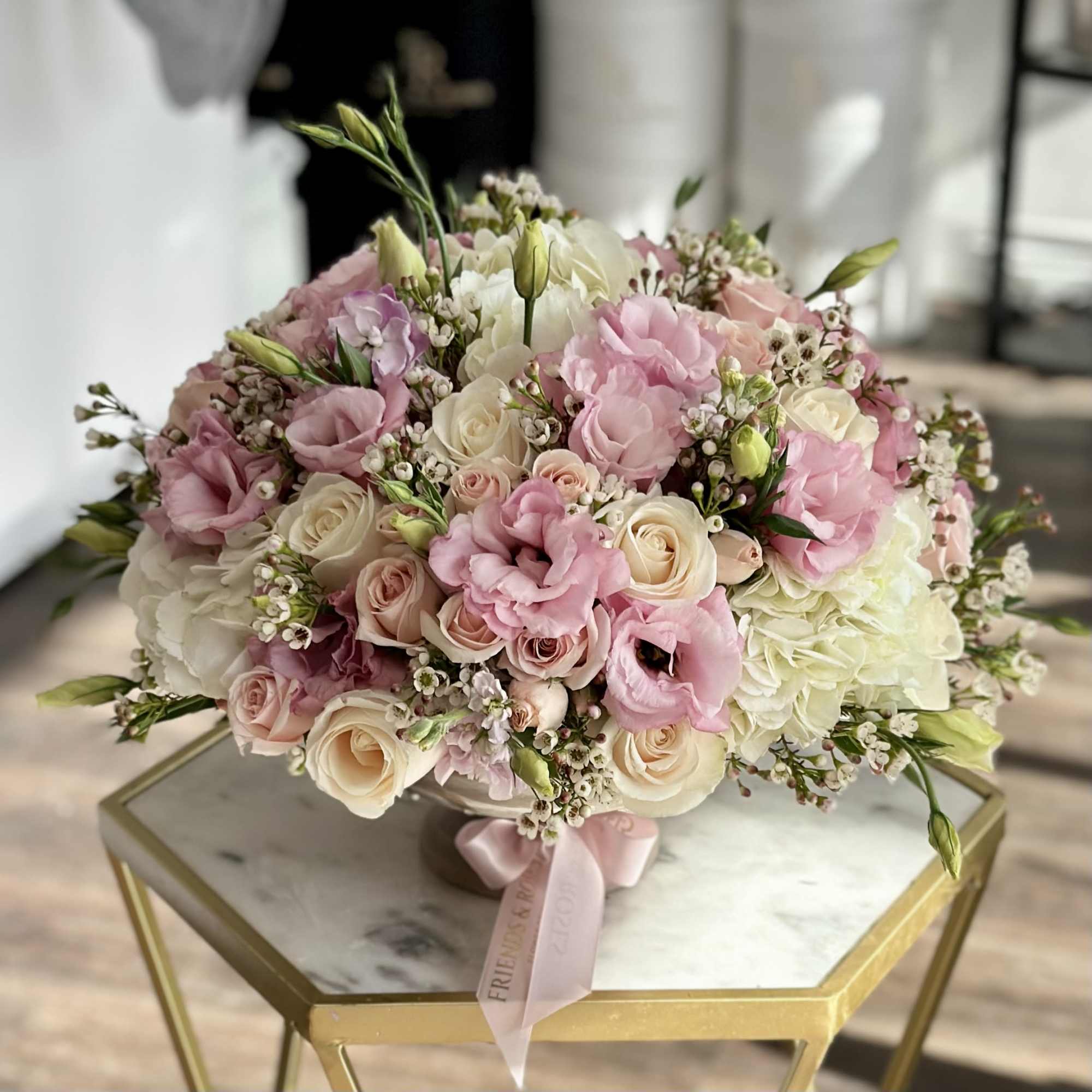 Pink and white rose bouquet with lisianthus on a table