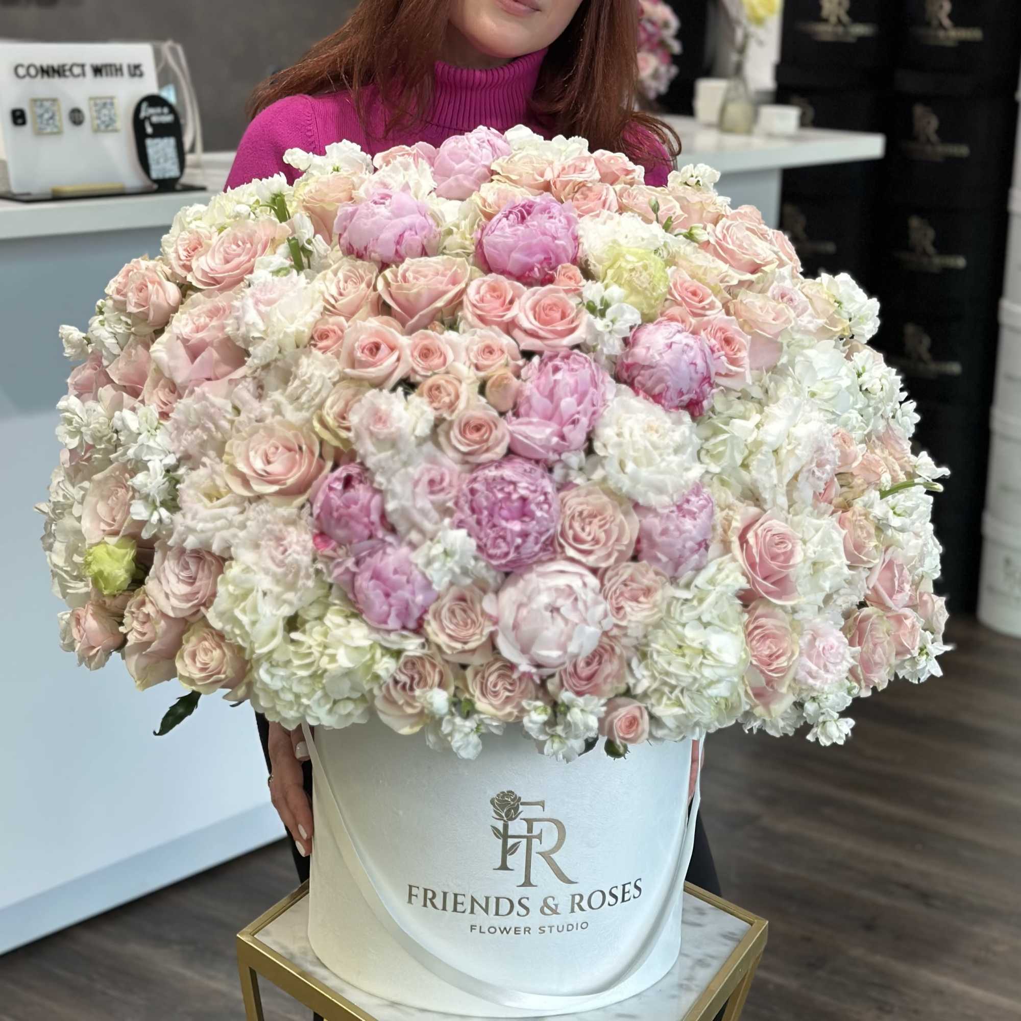 Large pastel bouquet of pink and white roses in a white hat box