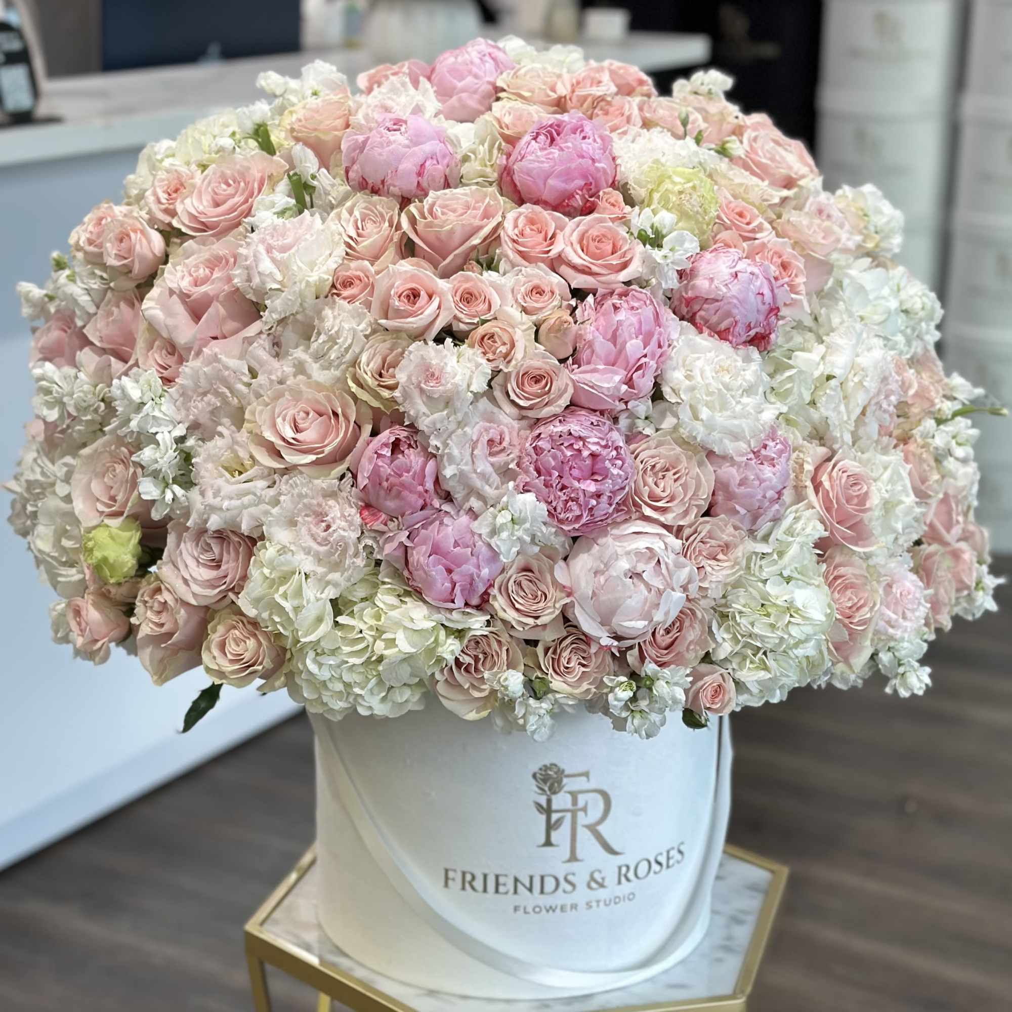 Large pastel bouquet of pink and white flowers in a white hat box