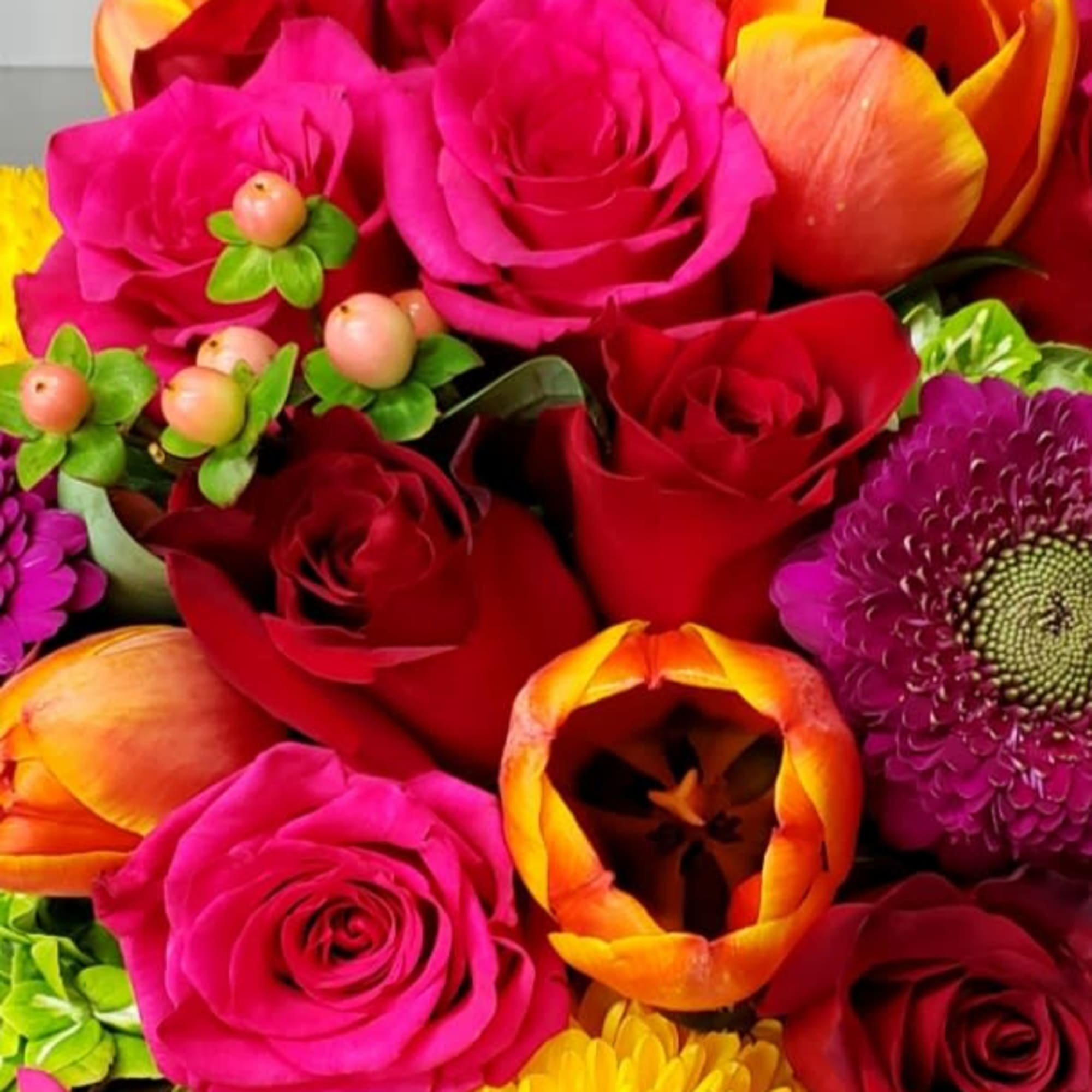 Bright mixed bouquet of roses, tulips, and chrysanthemums