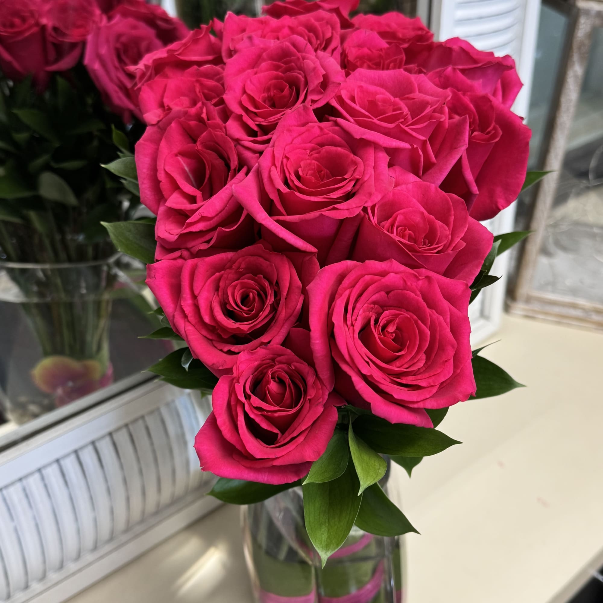 Bouquet of bright pink roses in a clear glass vase