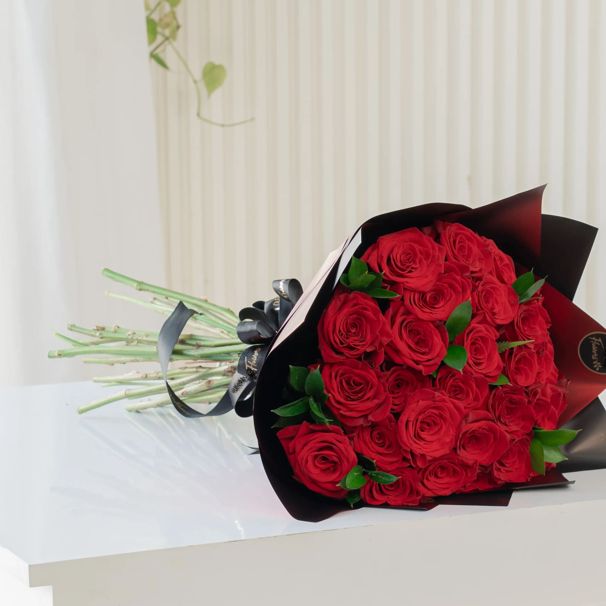 Bouquet of red roses wrapped in black paper