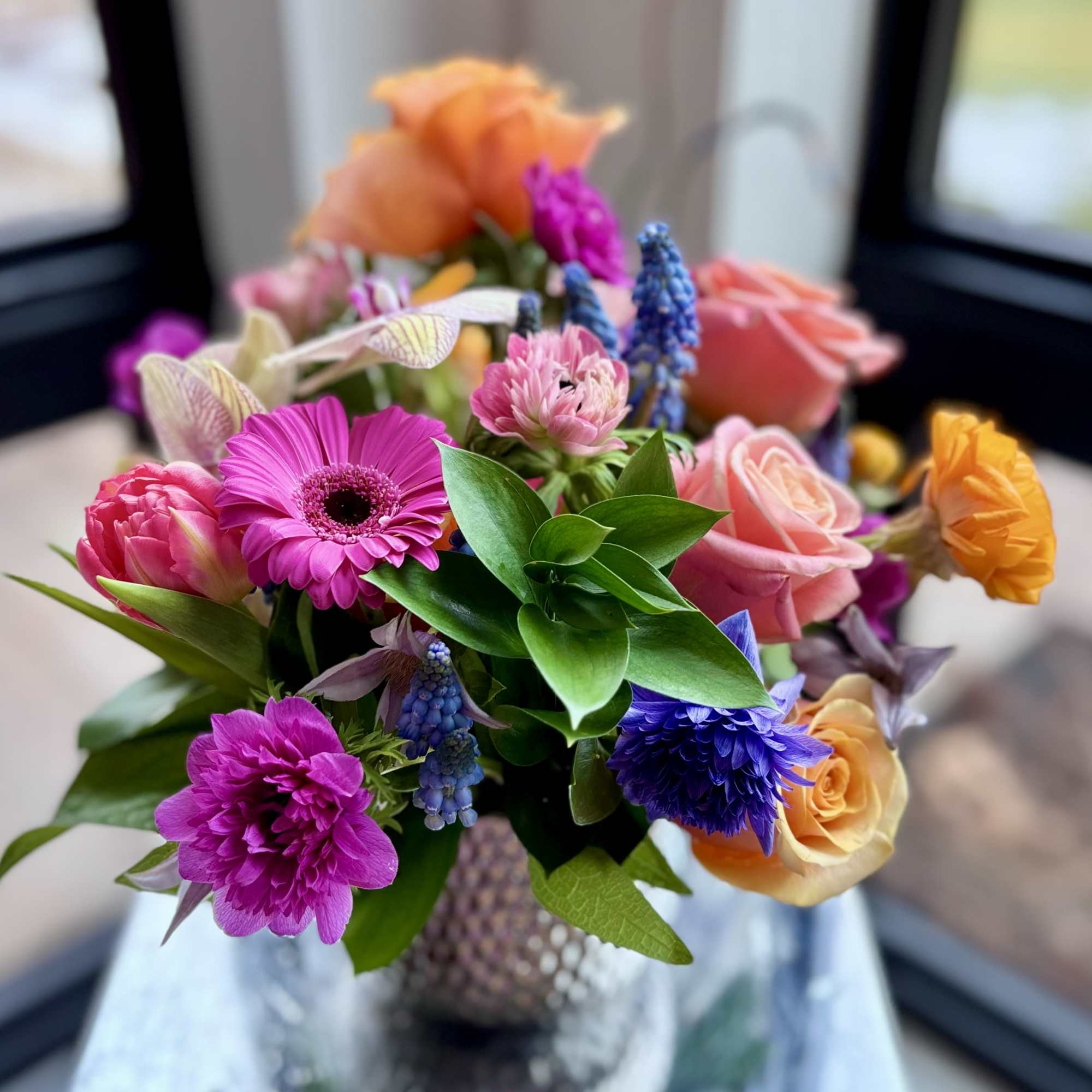 Cute colorful flower arrangement of premium flowers in a silver Supernova Pot