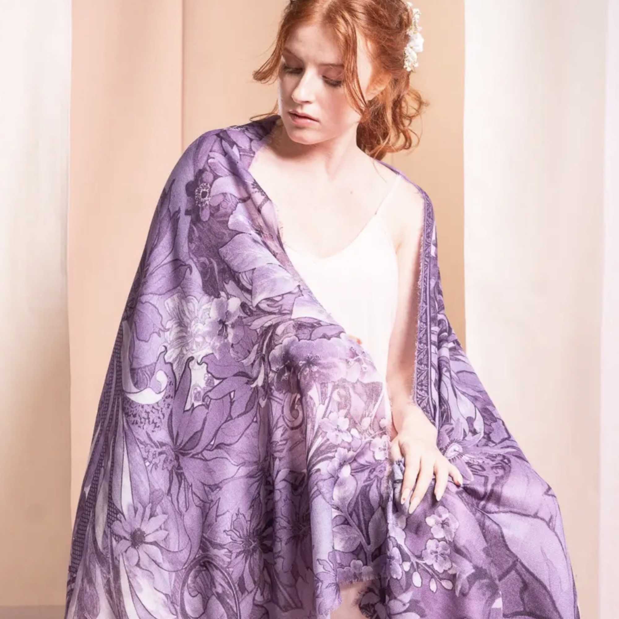 Woman wearing a purple floral shawl over a light dress