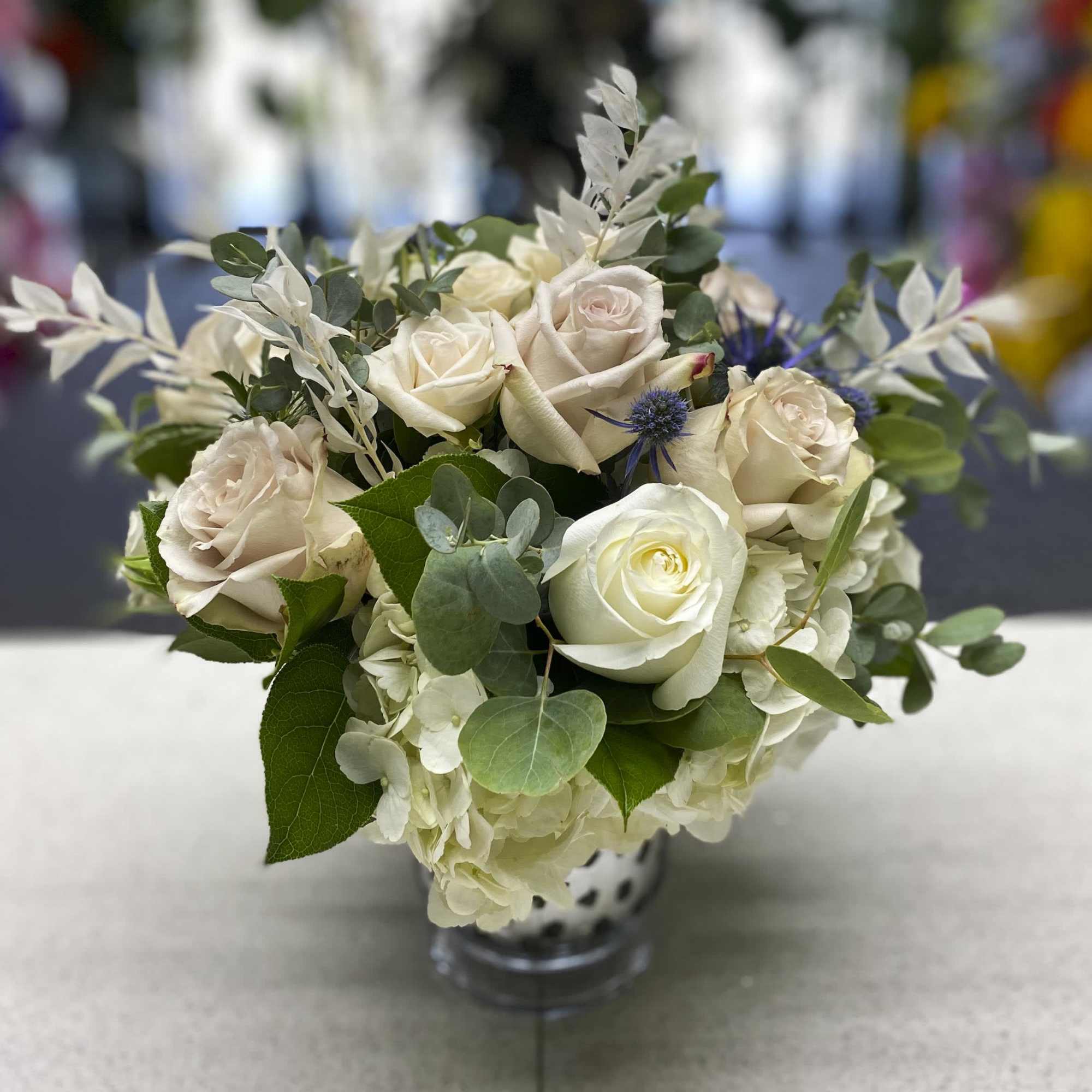 Cream roses and white hydrangeas in a glass vase