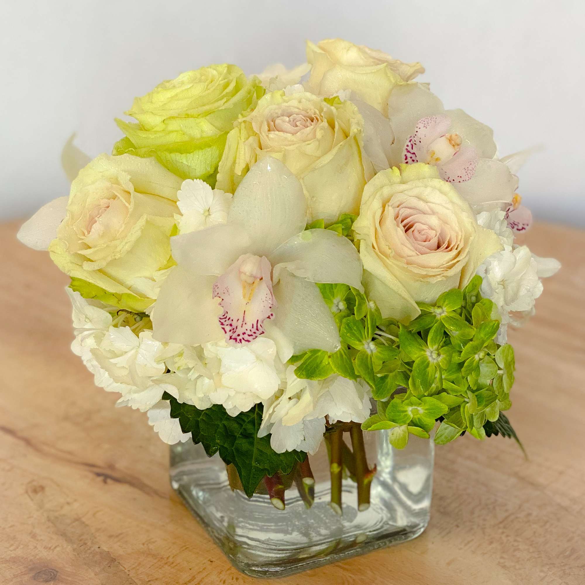 This elegant bouquet of cymbidium orchids, roses and hydrangeas arranged in a, photo 6 of 7