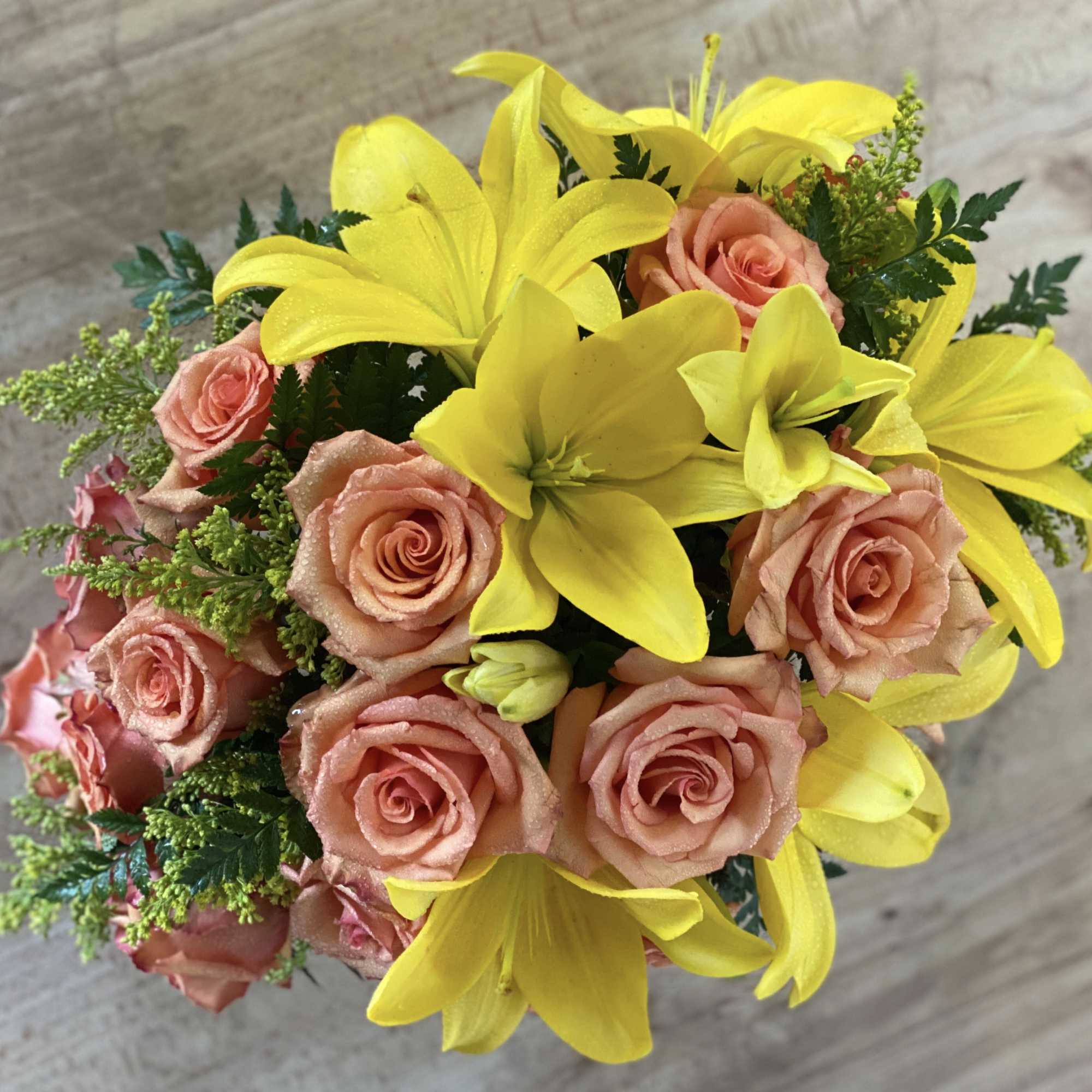 Bouquet of yellow lilies and peach roses