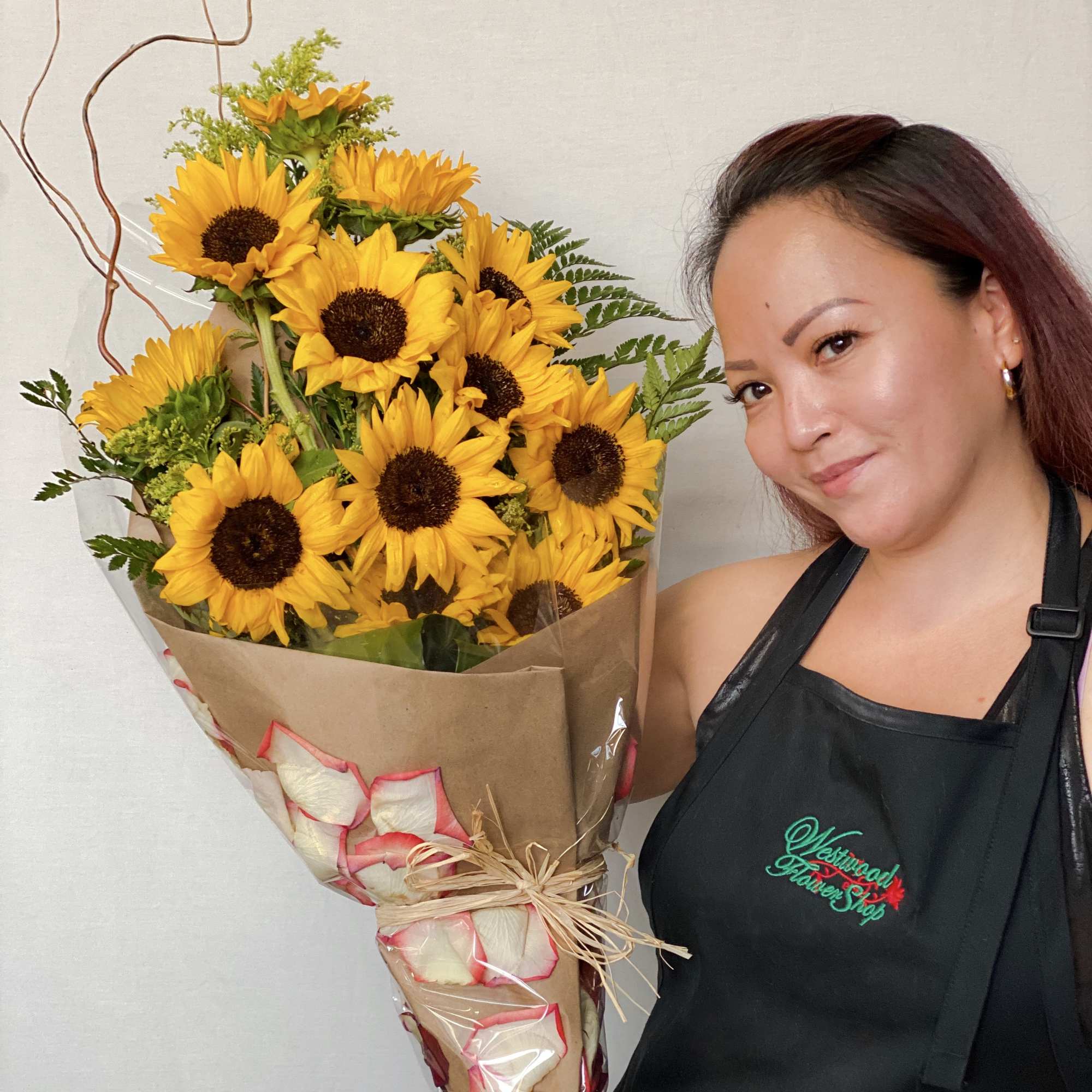 Bouquet of yellow sunflowers wrapped in brown paper