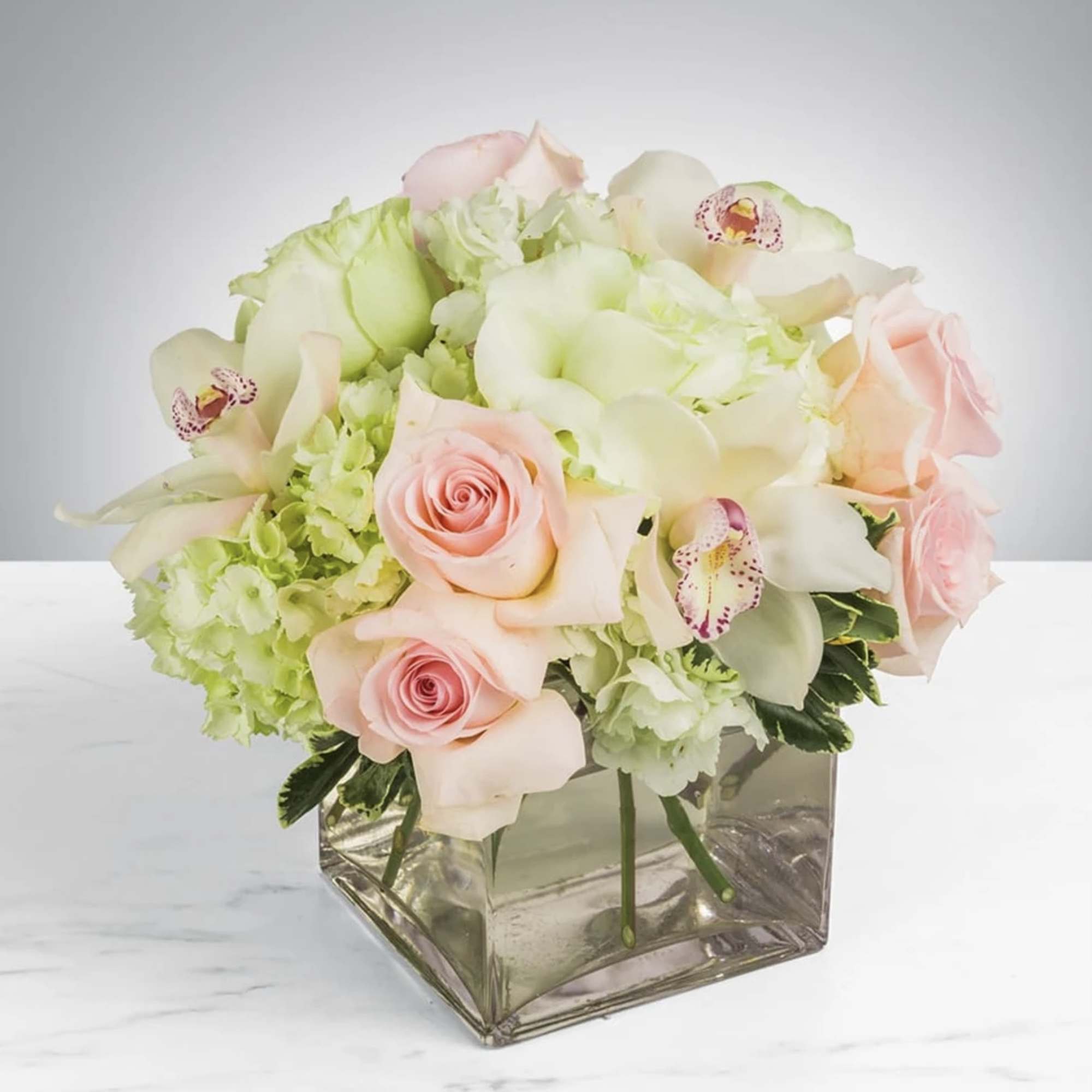 This elegant bouquet of cymbidium orchids, roses and hydrangeas arranged in a