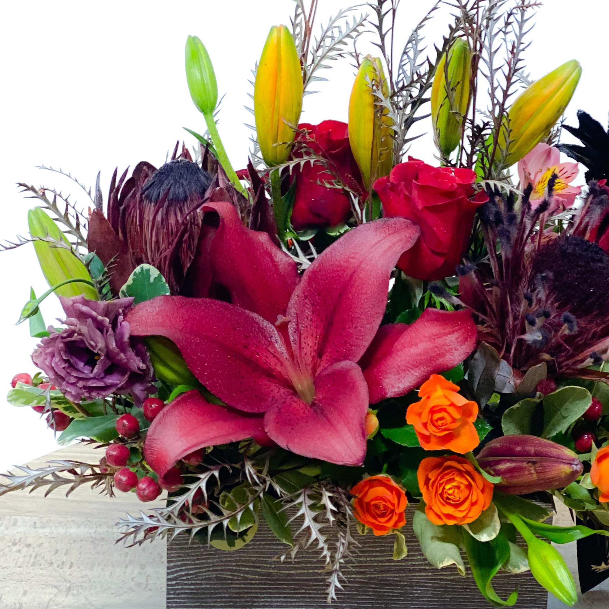 Mixed bouquet with red lilies, roses, and orange spray roses