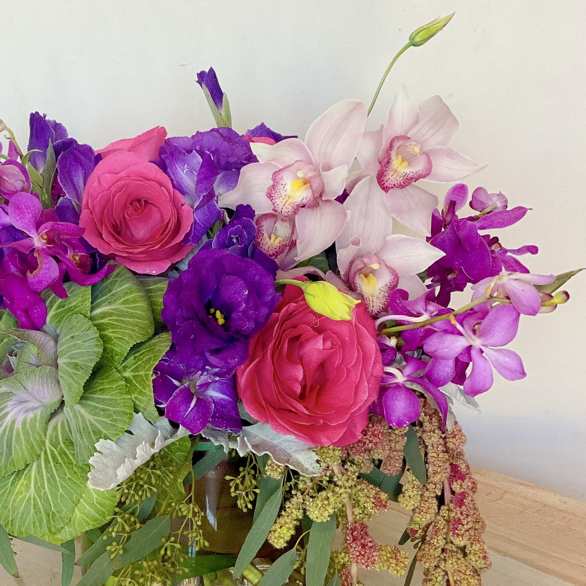 Bouquet of pink roses, purple orchids, and pale pink orchids