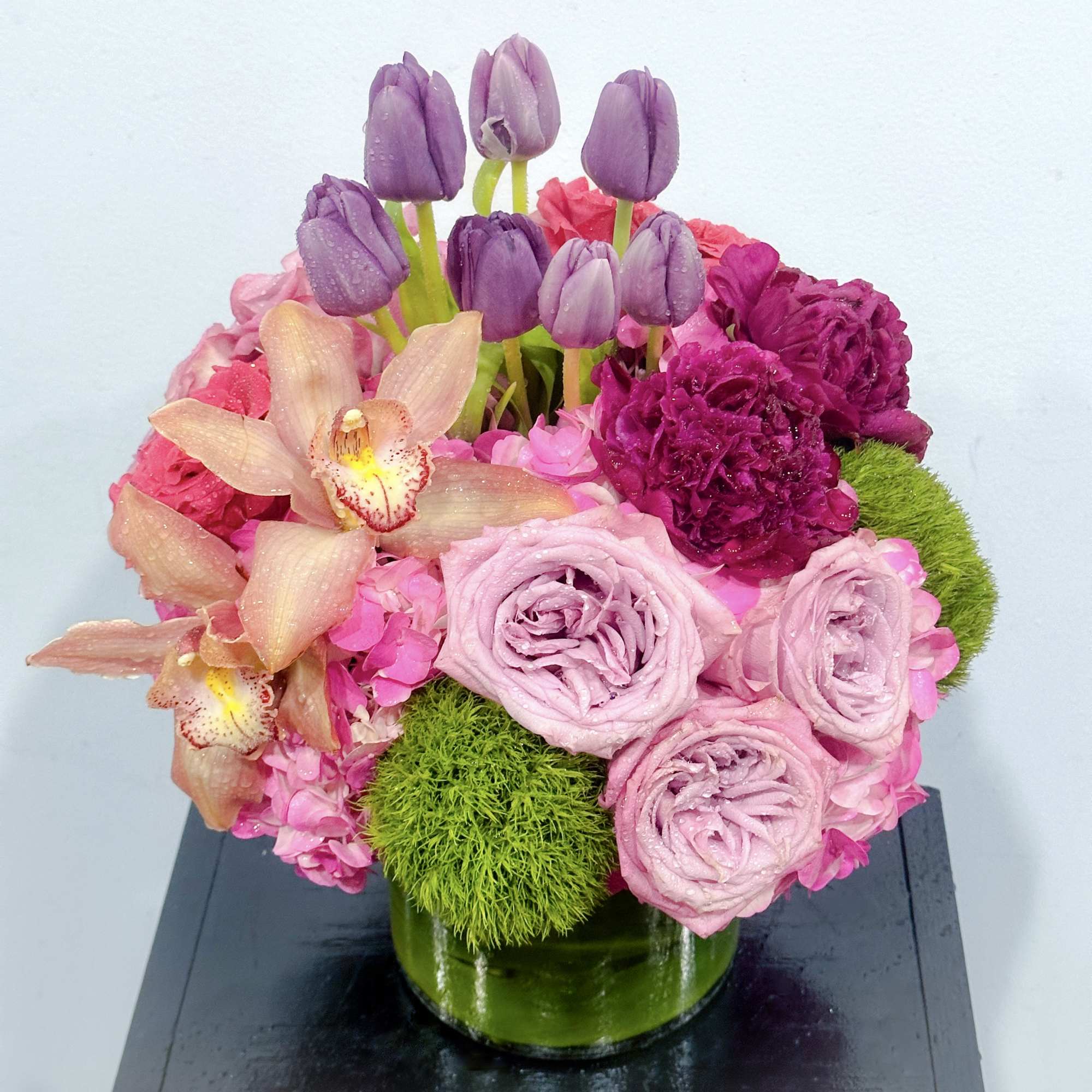 Pink and purple floral arrangement in a glass vase