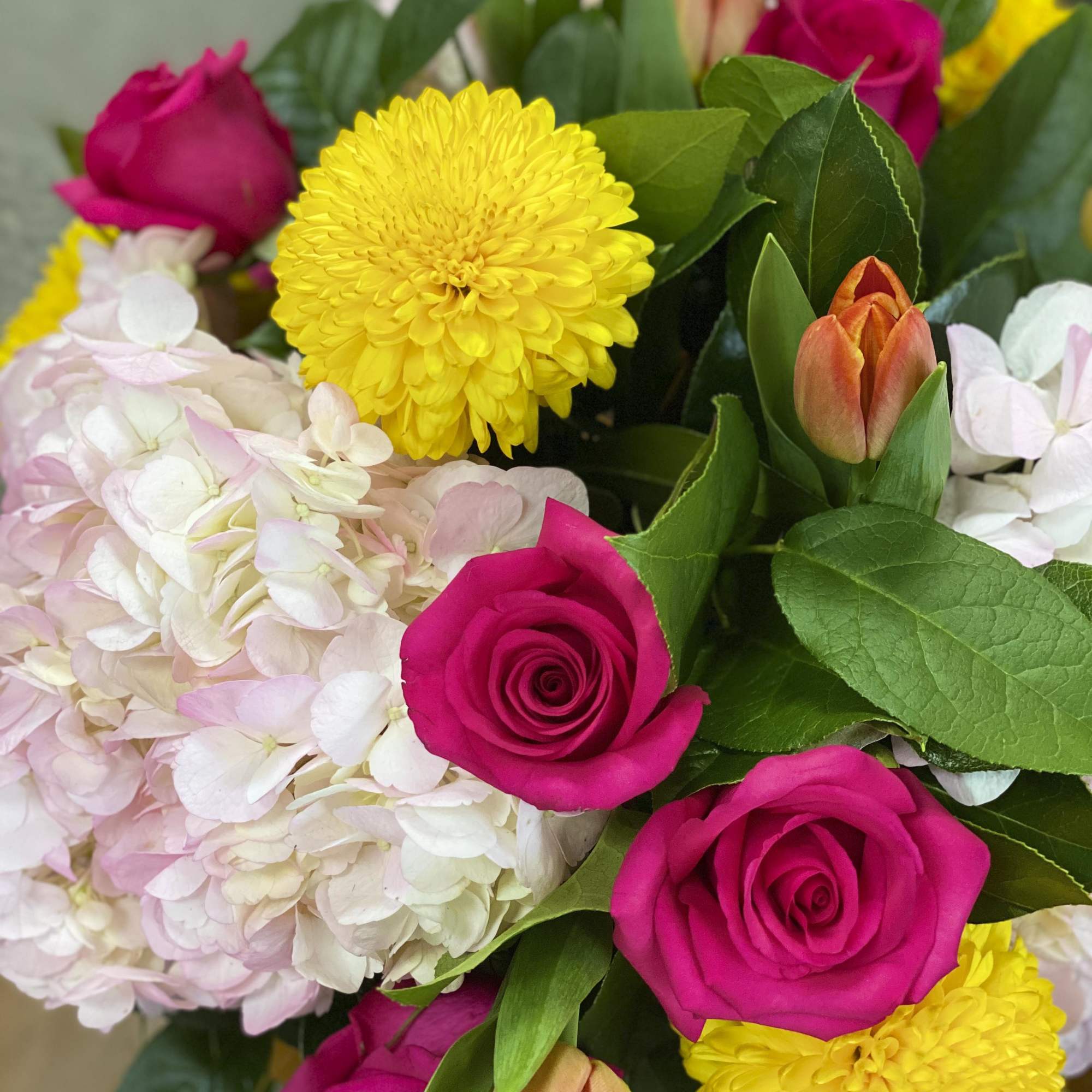 Bouquet of pink roses, yellow chrysanthemums, and pale hydrangeas