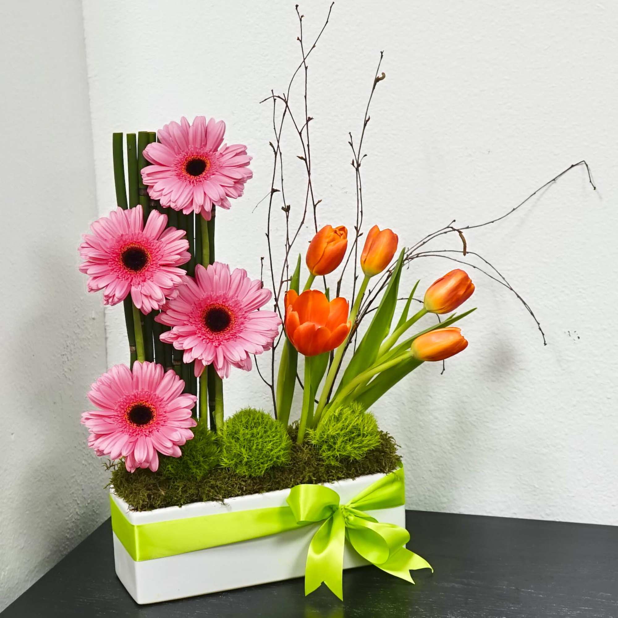 Pink gerbera daisies and orange tulips in a white box with a green ribbon, photo 3 of 4