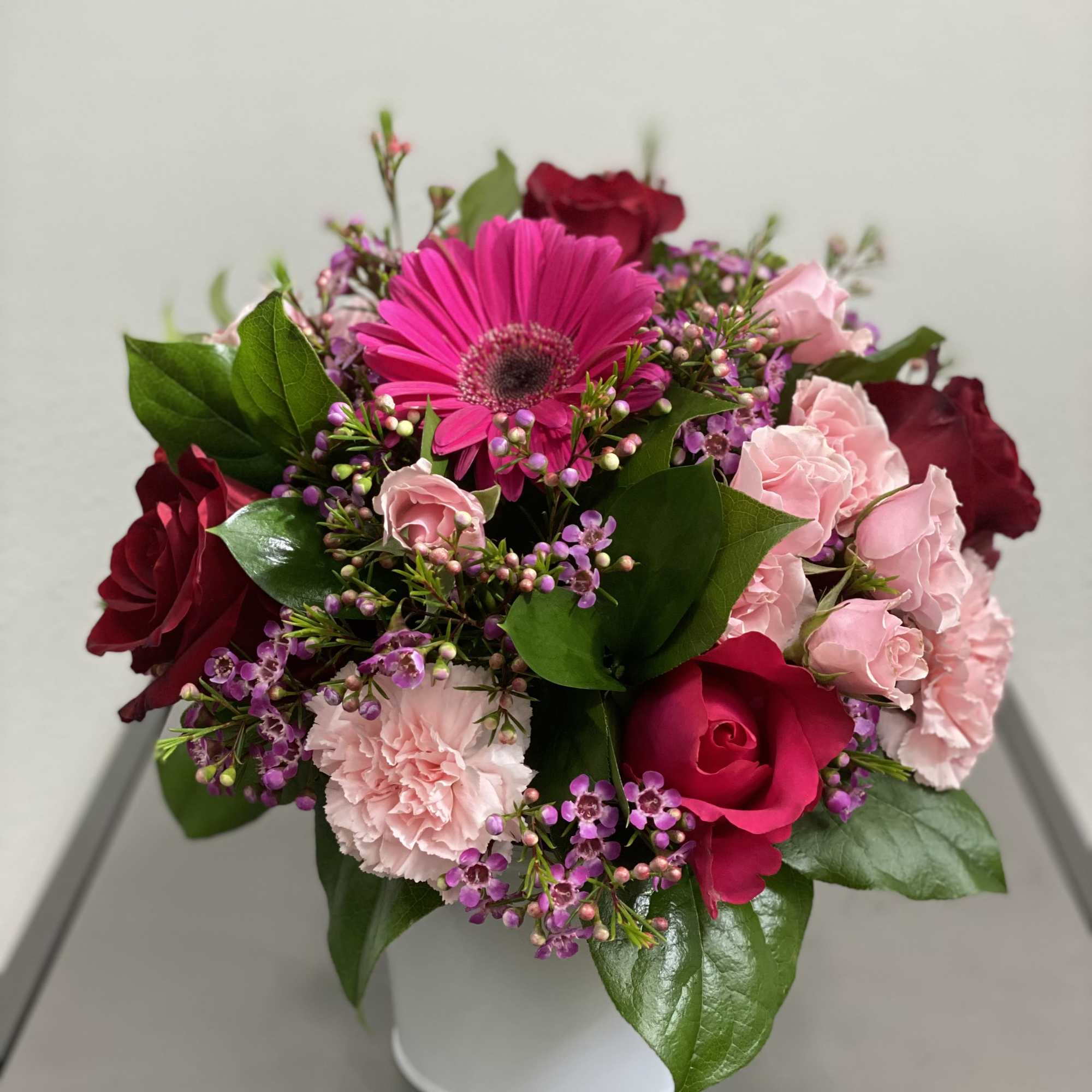 Pink and red mixed bouquet in a white vase