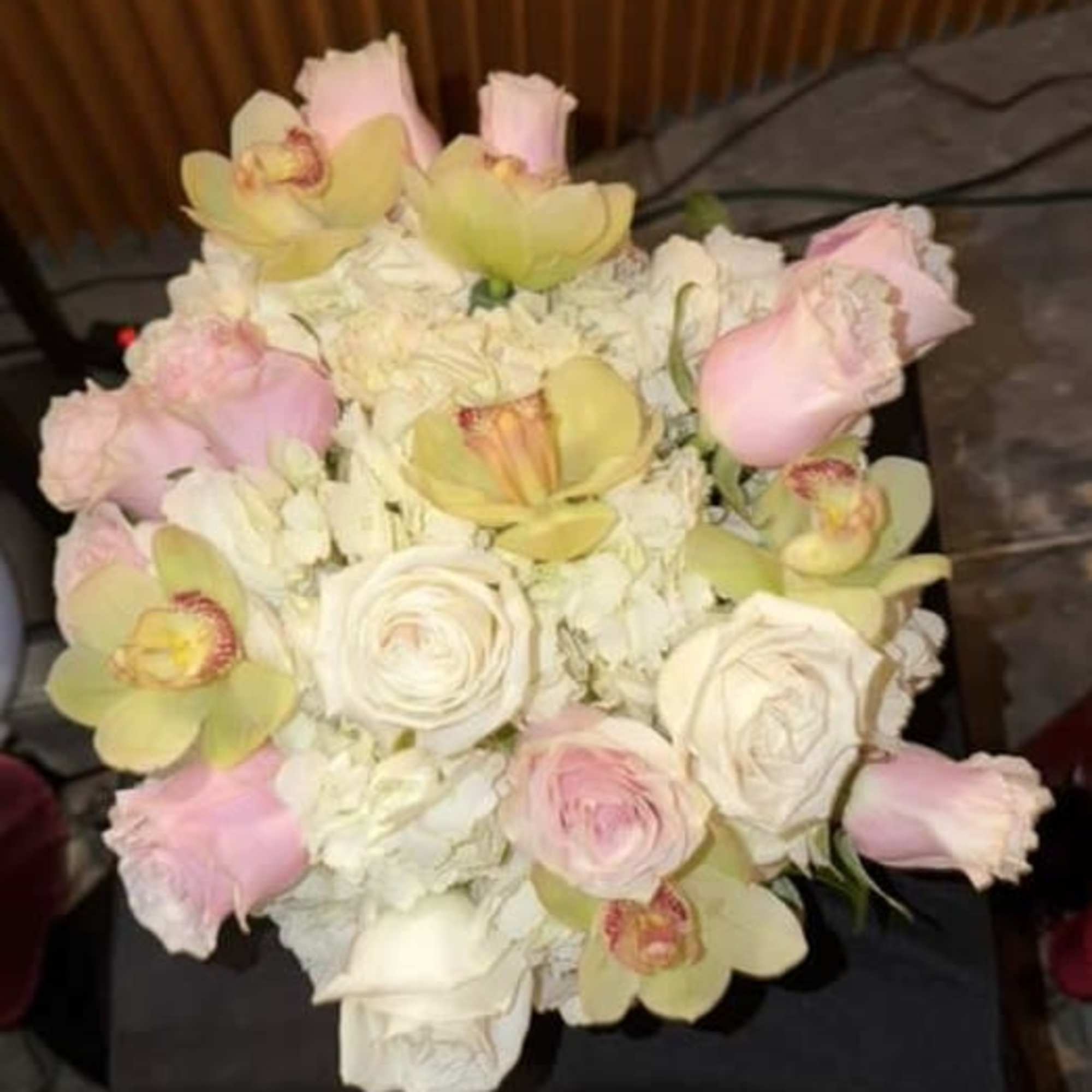 Bouquet of pale pink roses and green orchids with white flowers