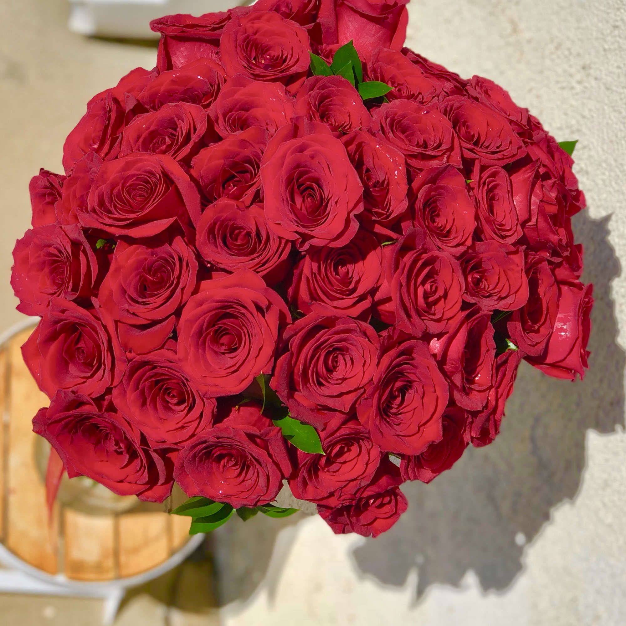 Bouquet of red roses with a few green leaves