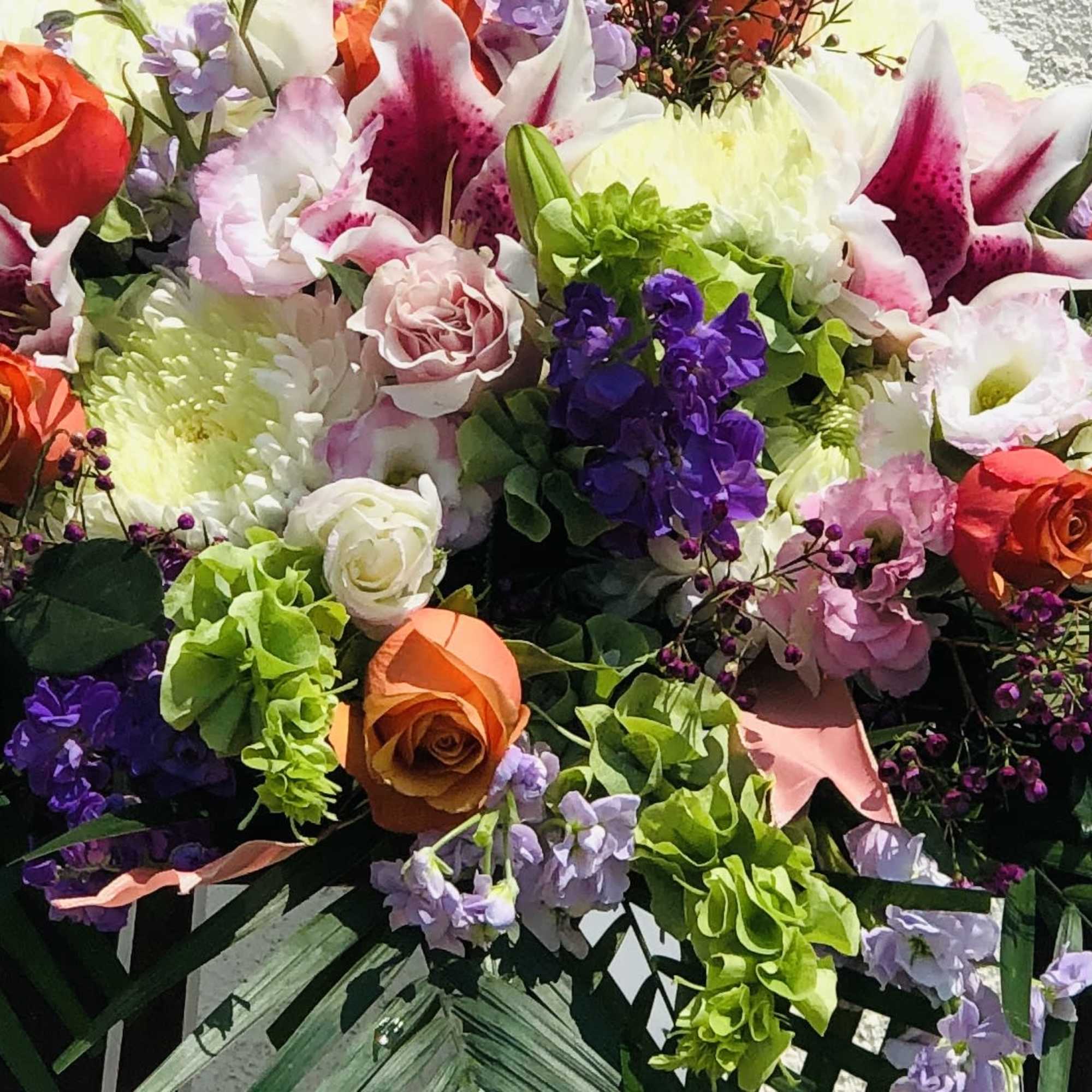 Mixed bouquet with roses, lilies, and purple flowers