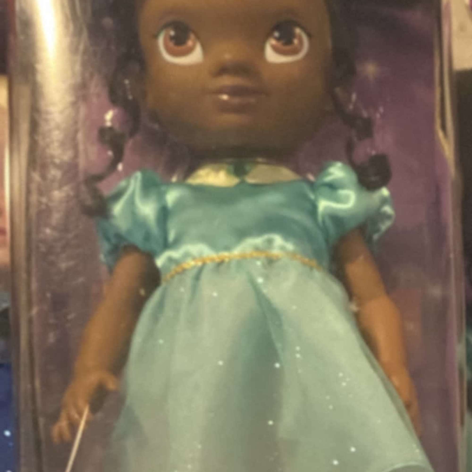 Disney toddler doll in a turquoise dress inside retail packaging