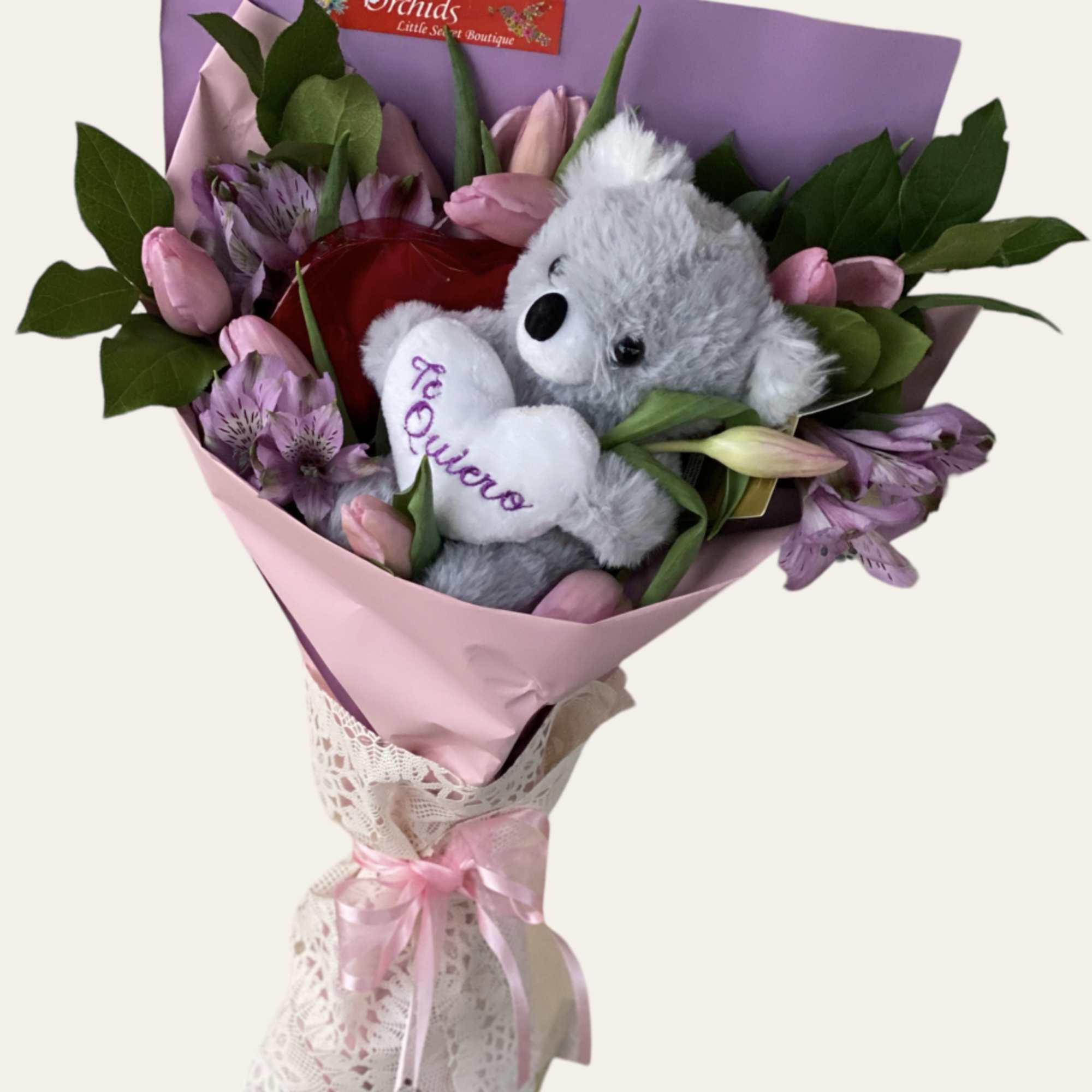 Pink bouquet with a gray teddy bear and purple flowers