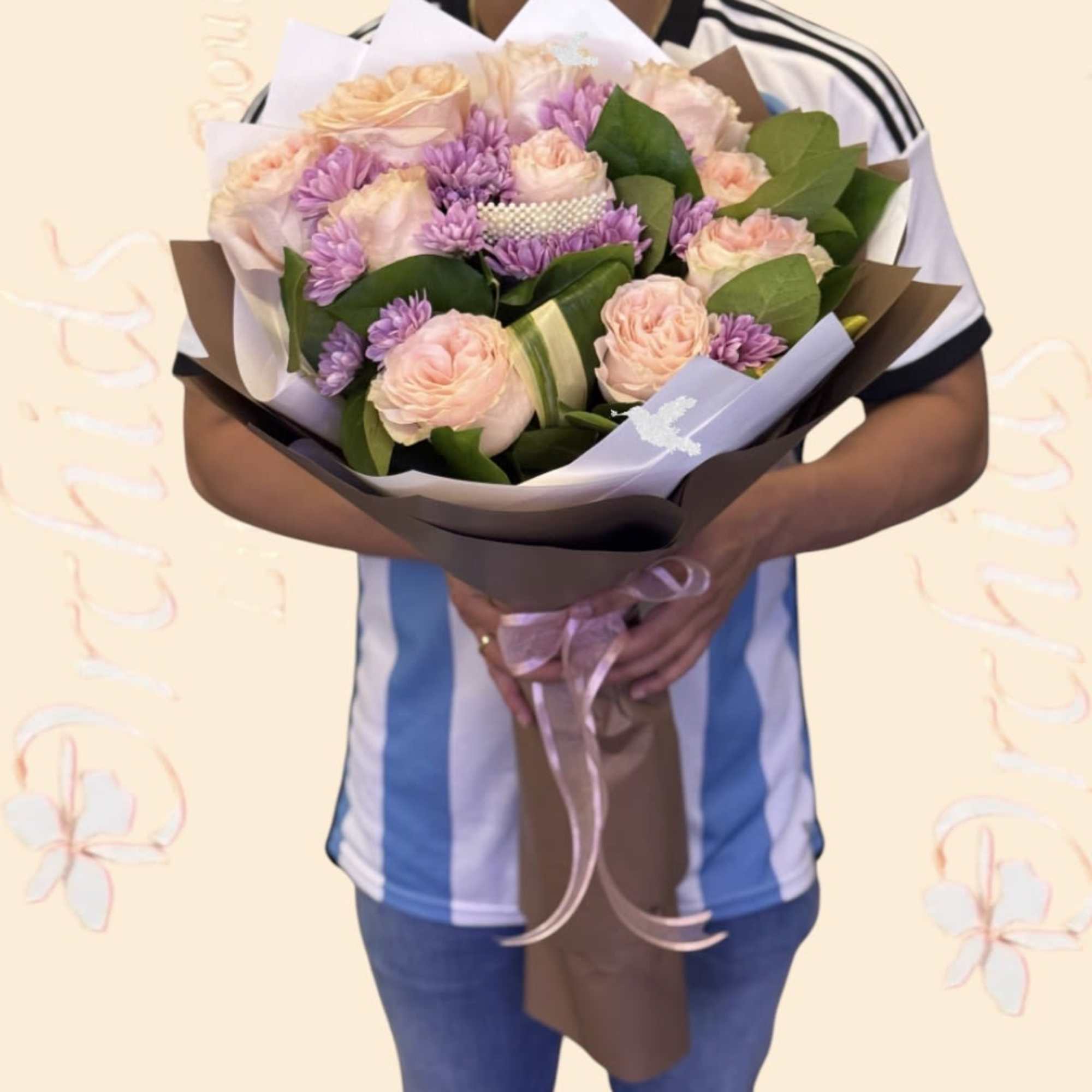 This luxury, hand-wrapped bouquet features premium light pink roses accented with lavender
